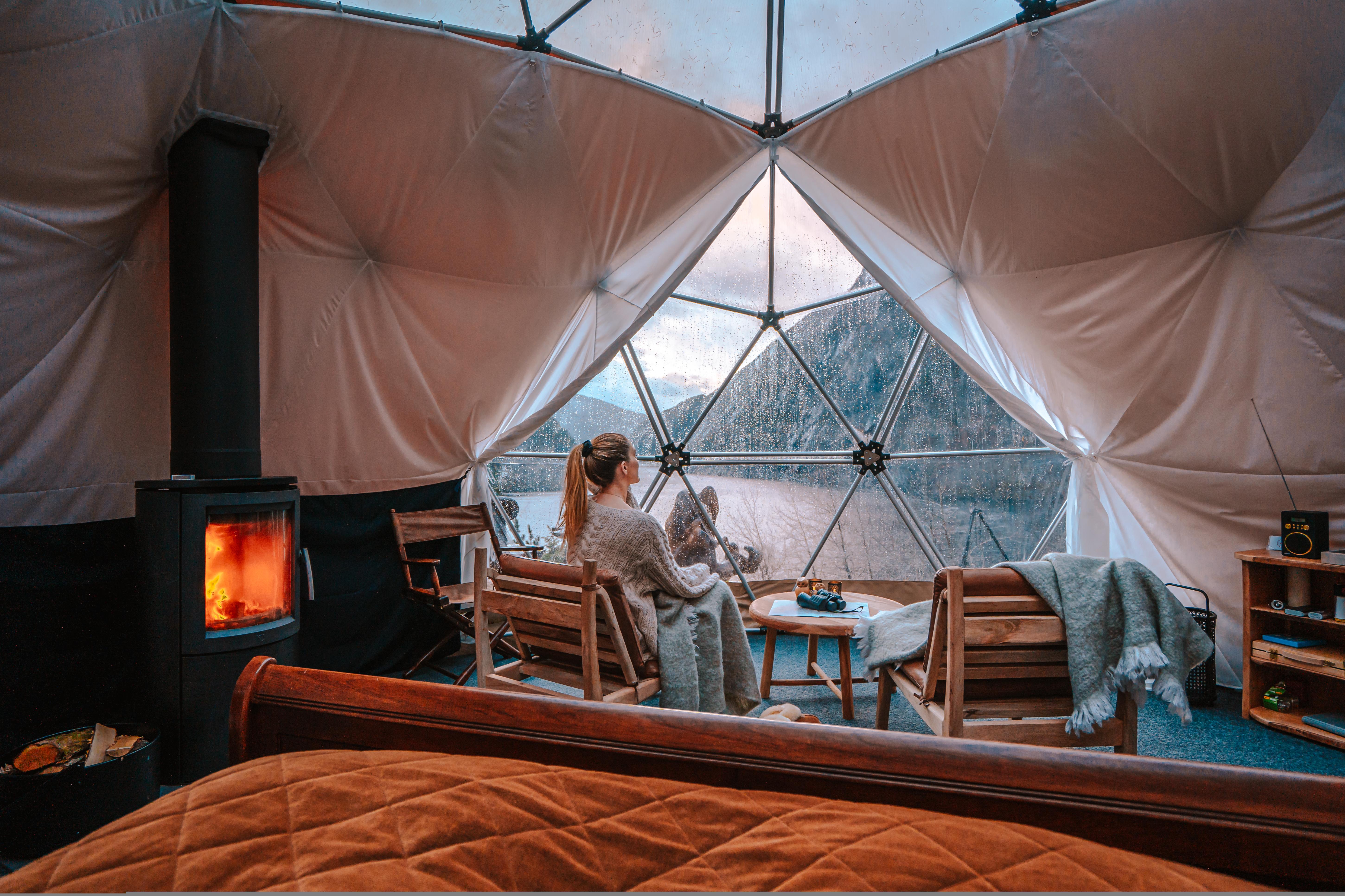 A woman enjoying the view from Åkrafjorden Glamping