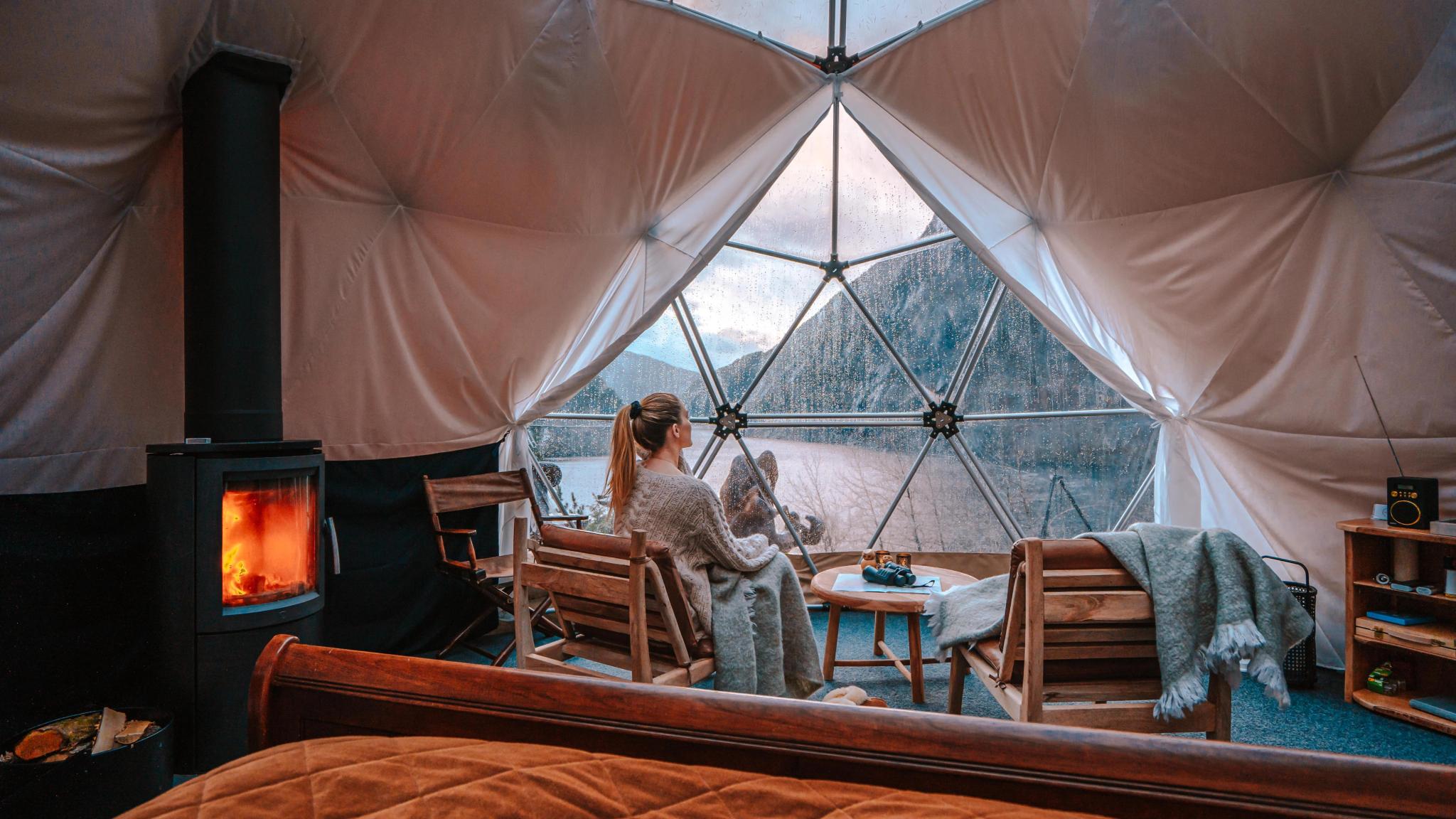 A woman enjoying the view from Åkrafjorden Glamping