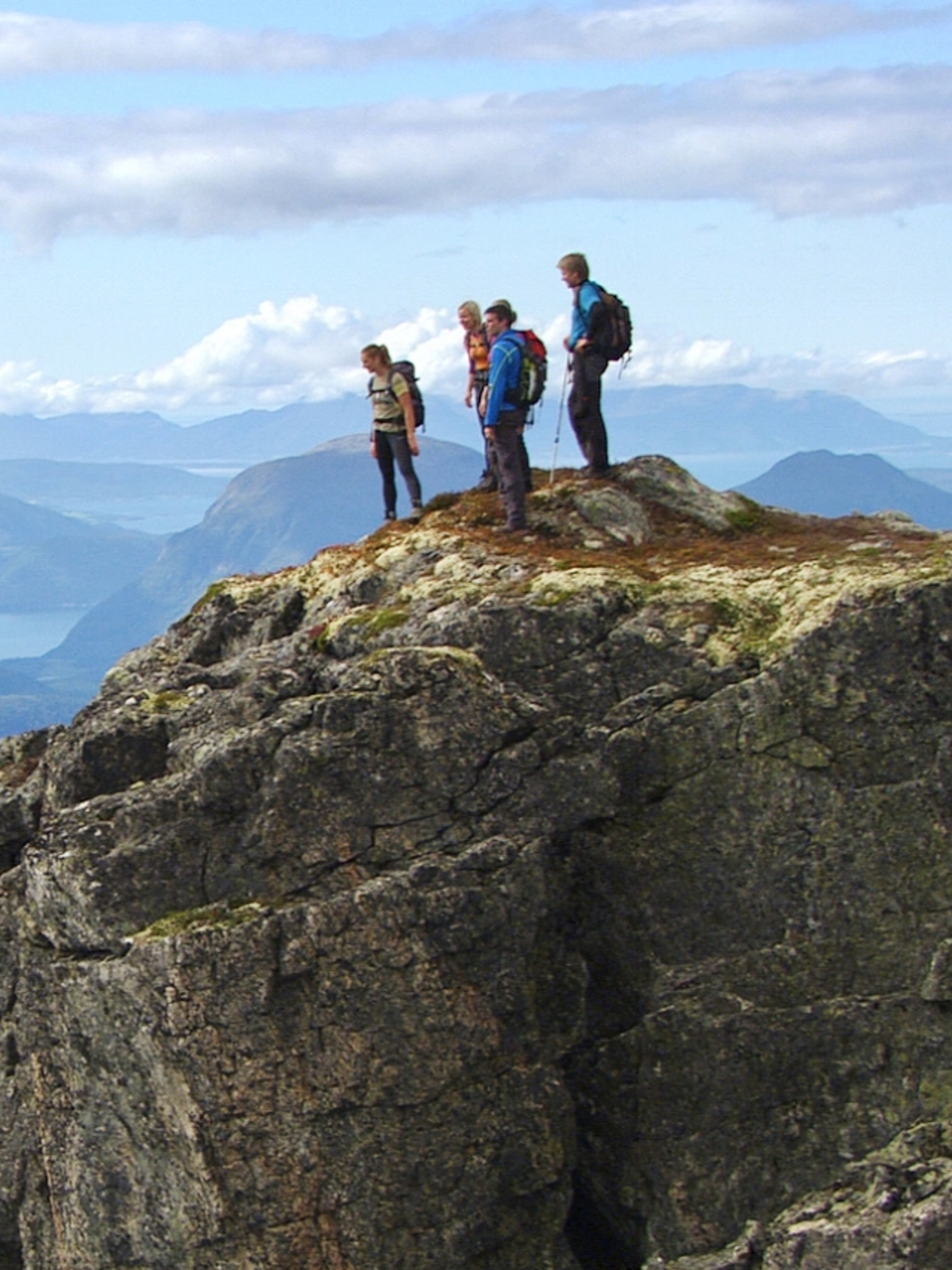 A group of people admire the view from Romsdalseggen in Fjord Norway