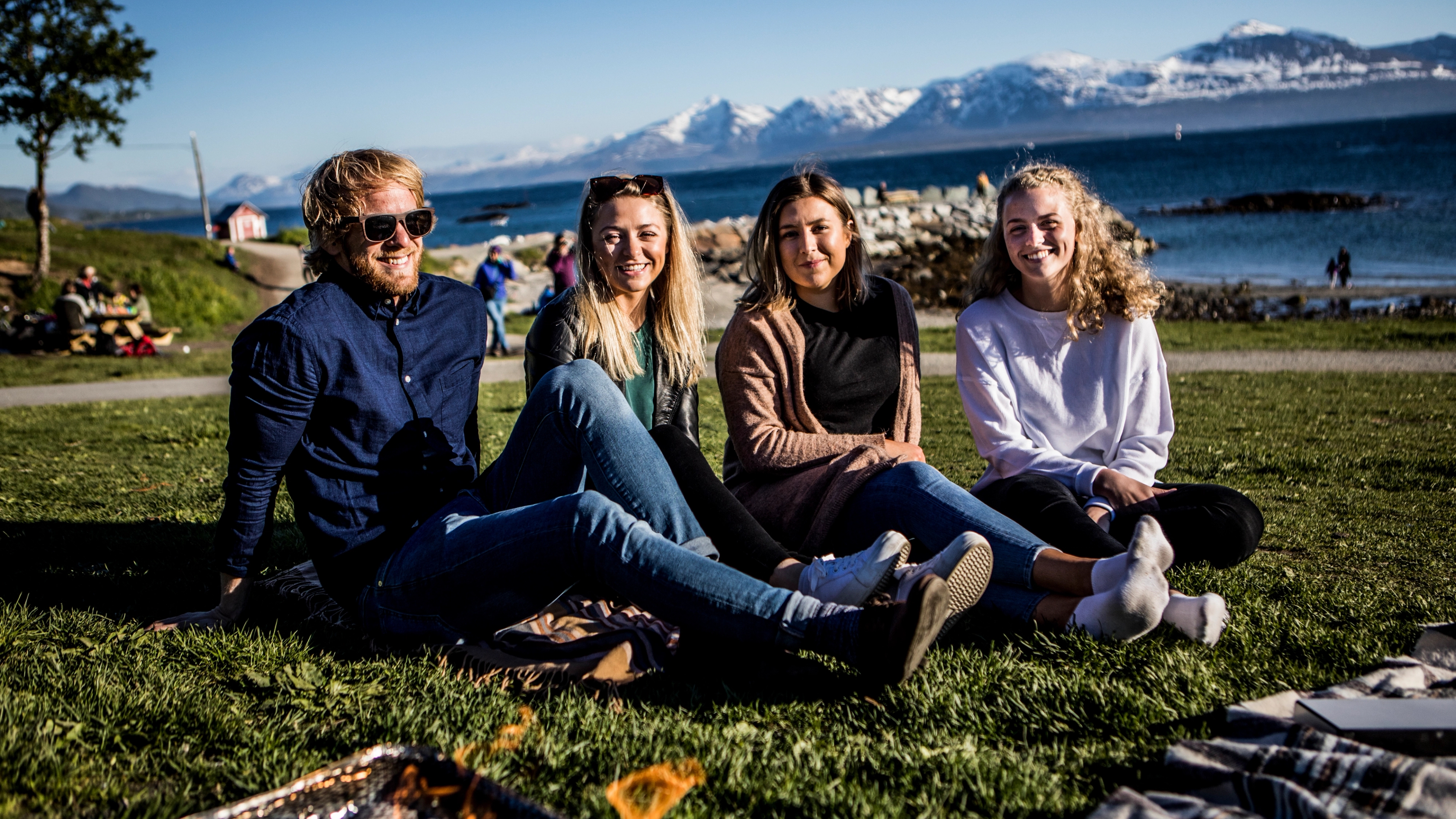 A group of friends is barbecuing at the Telegrafbukta bay in Tromsø, Northern Norway
