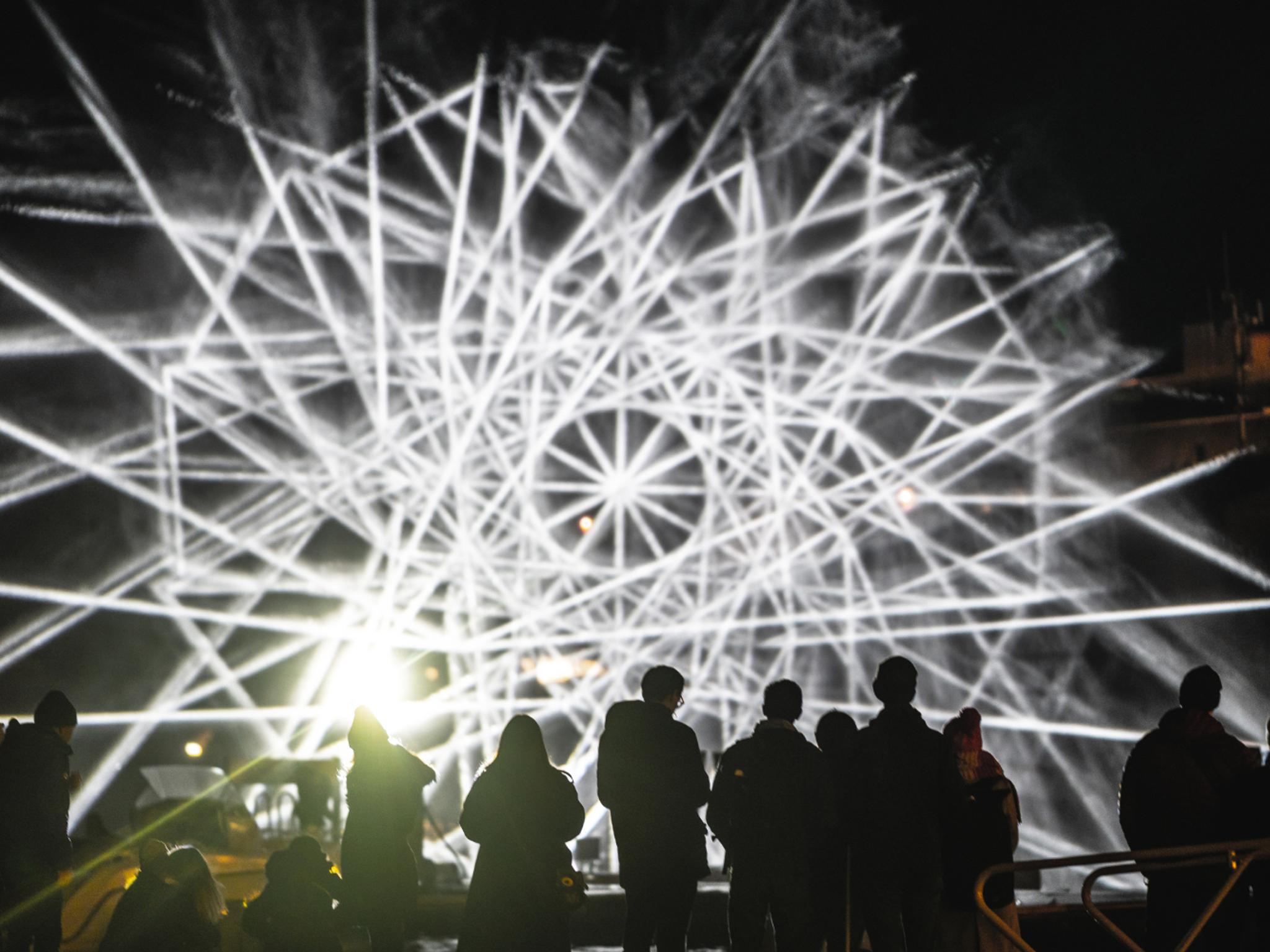People watching light art at Fjord Oslo light art festival