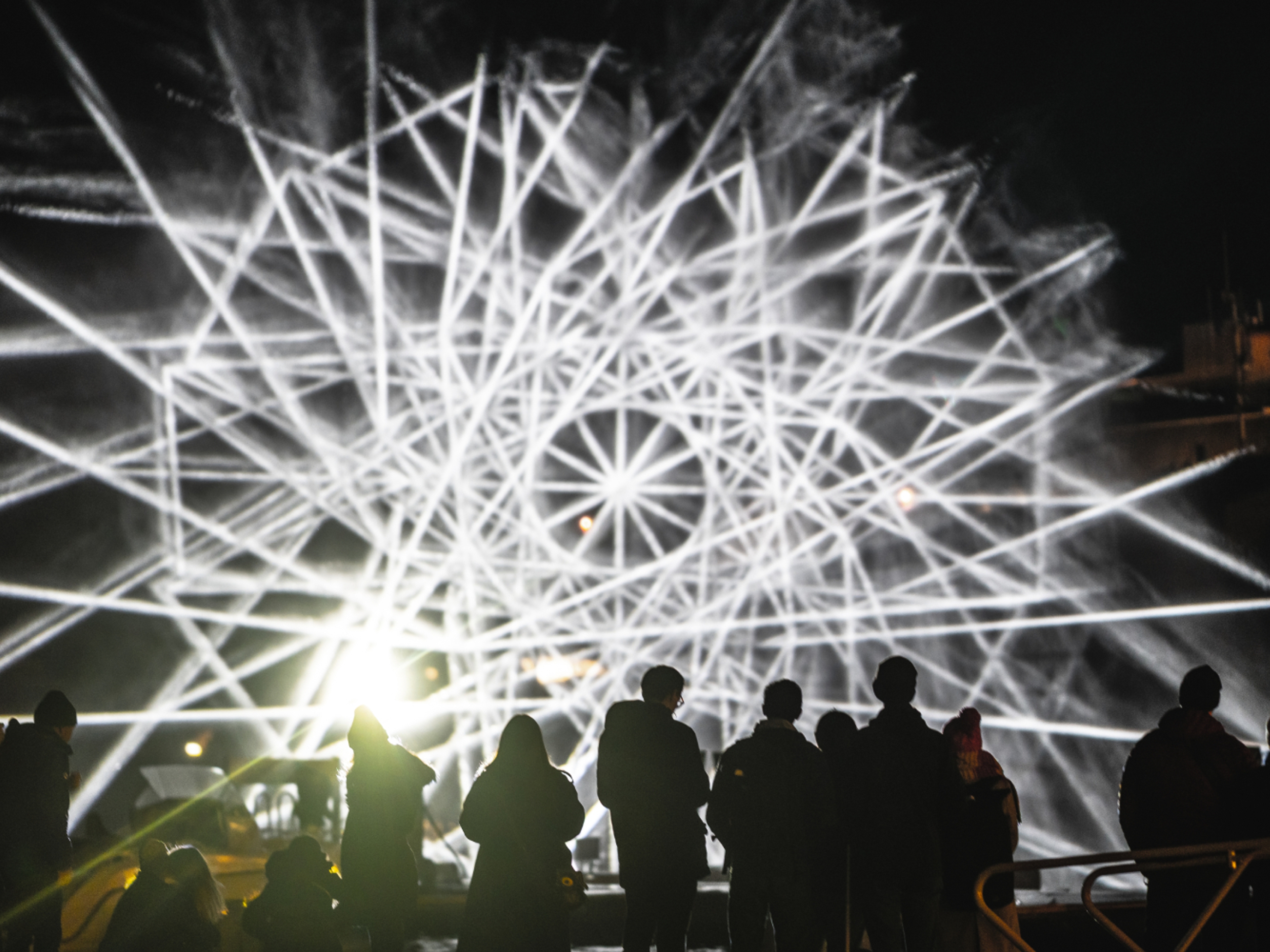People watching light art at Fjord Oslo light art festival