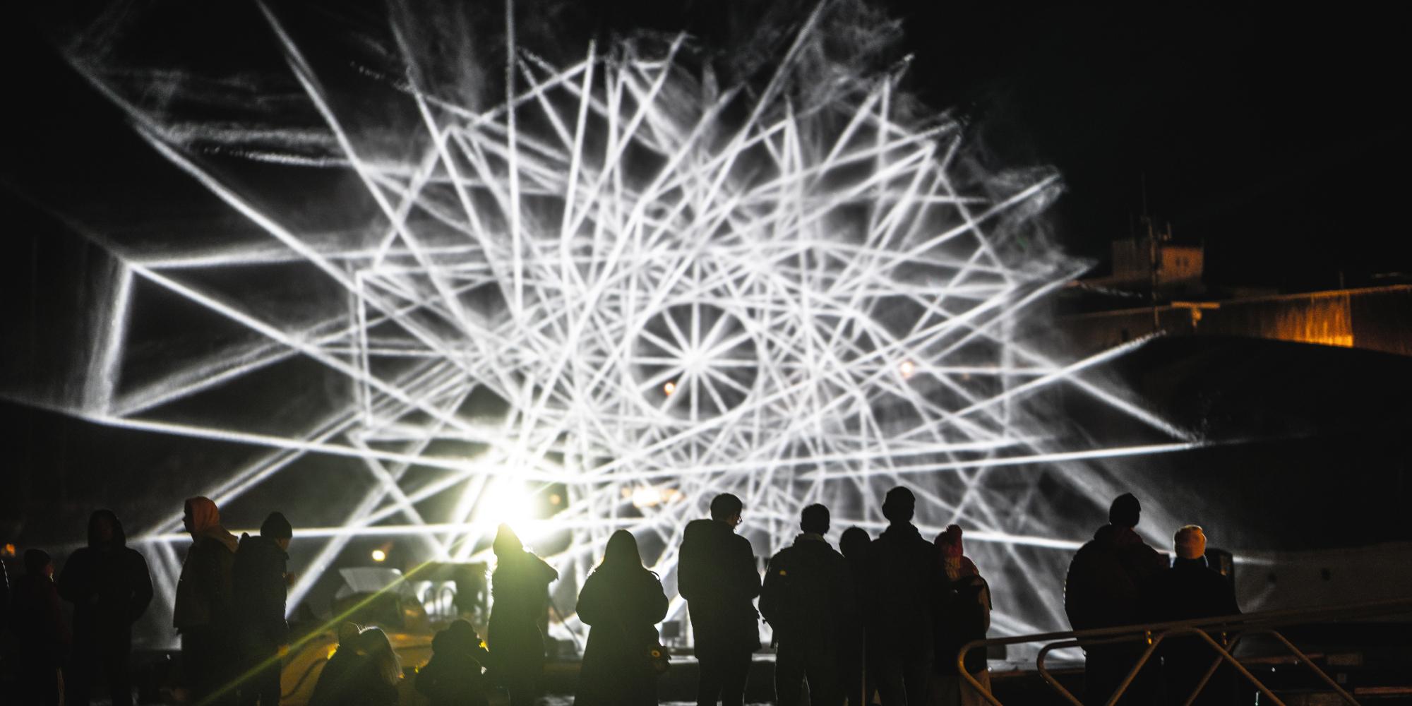 People watching light art at Fjord Oslo light art festival