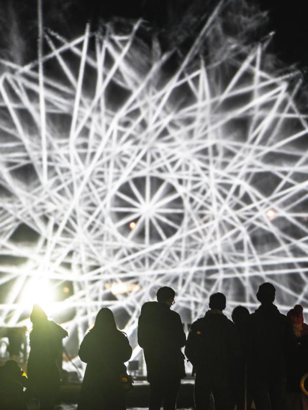 People watching light art at Fjord Oslo light art festival