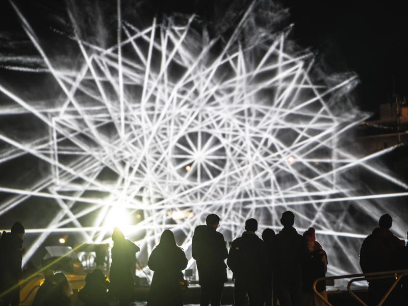 People watching light art at Fjord Oslo light art festival