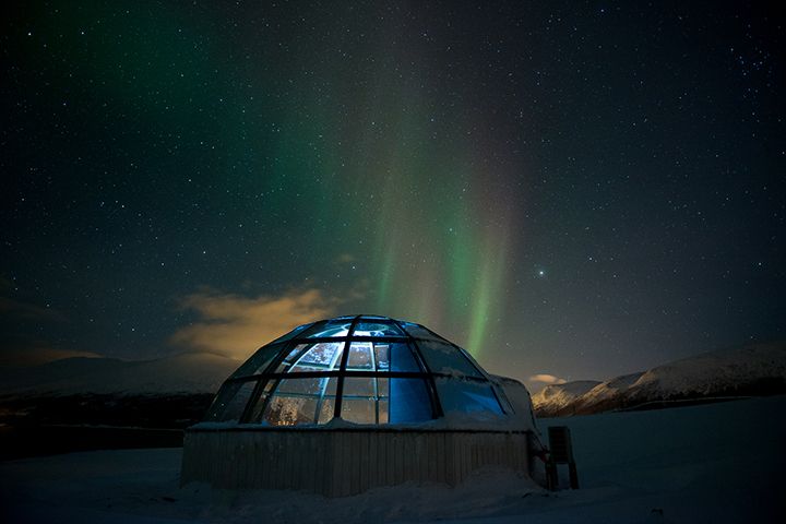 Glass igloo under the Northern Lights