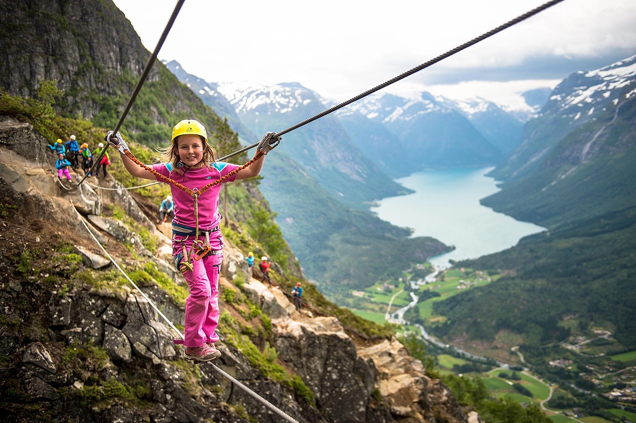 Young girl crossing the Via Ferrata in Loen in Fjord Norway