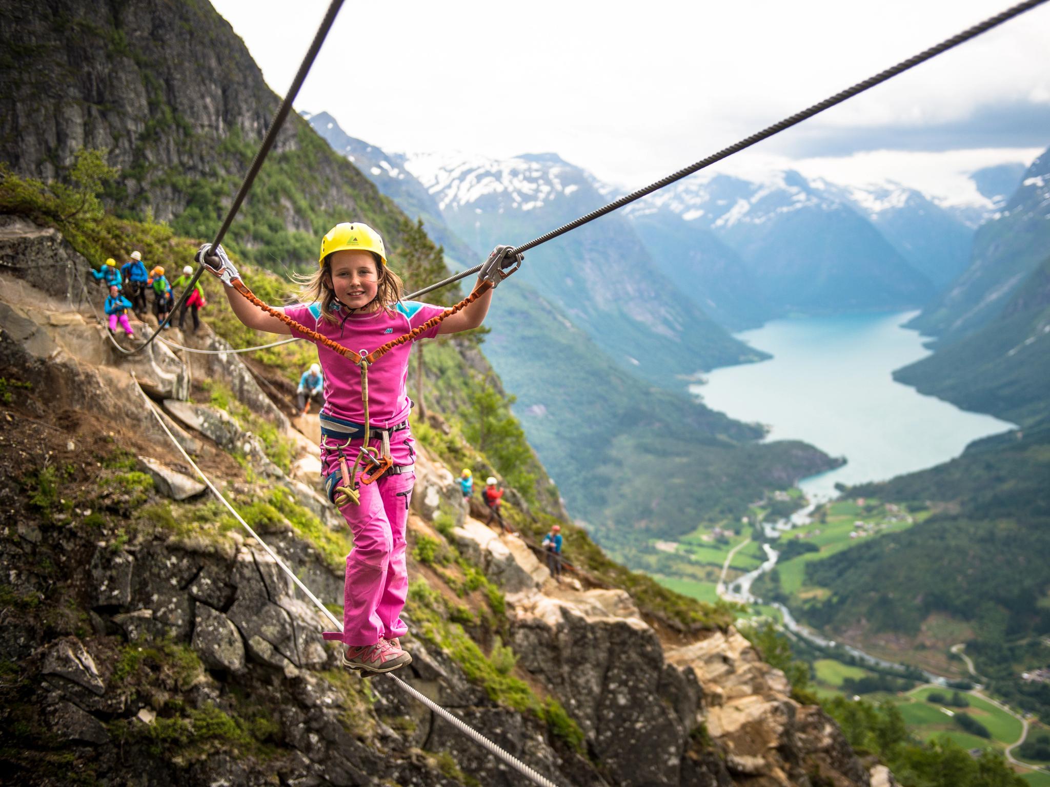 Young girl crossing the Via Ferrata in Loen in Fjord Norway