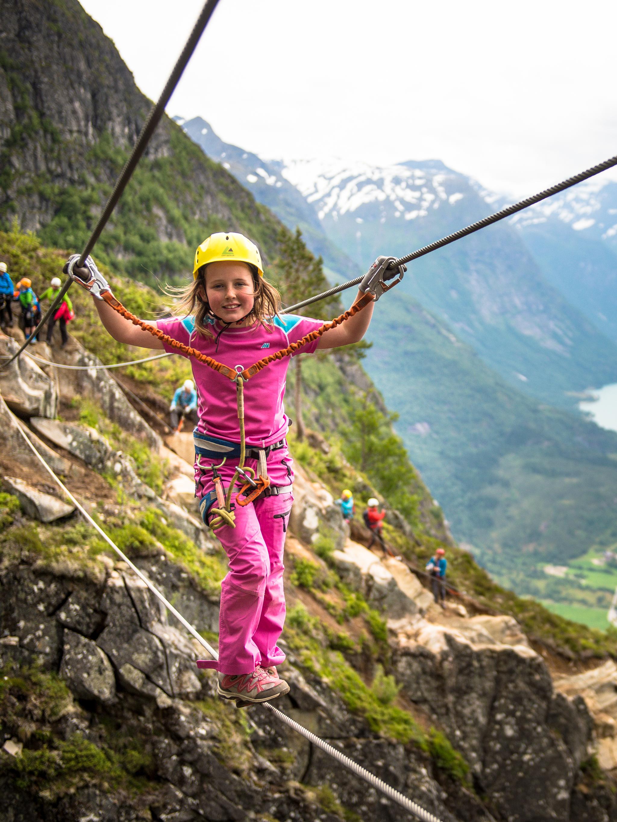 Young girl crossing the Via Ferrata in Loen in Fjord Norway