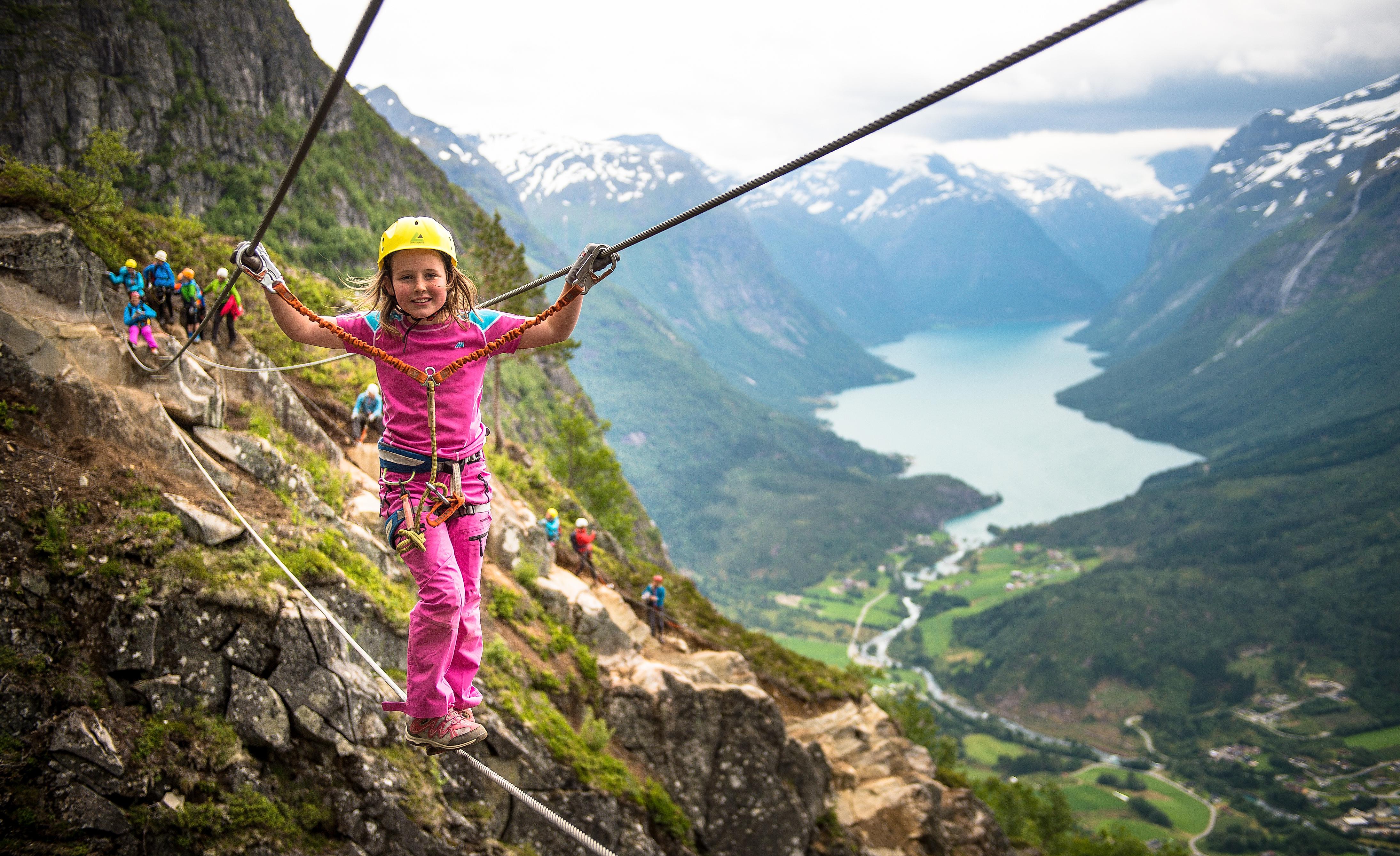 Young girl crossing the Via Ferrata in Loen in Fjord Norway
