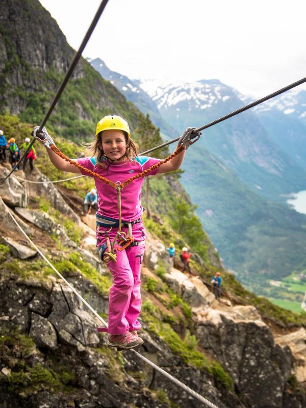 Young girl crossing the Via Ferrata in Loen in Fjord Norway