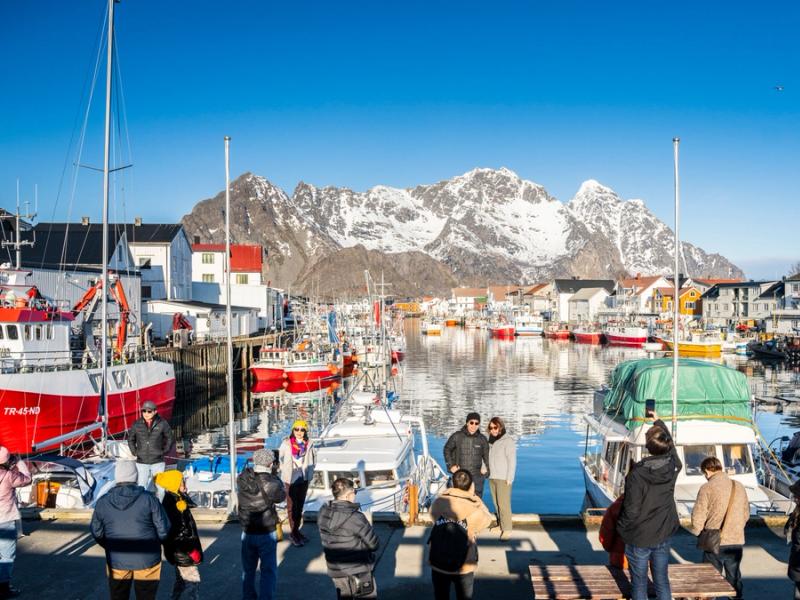 Tourists enjoying the view on the dock in Henningsvær