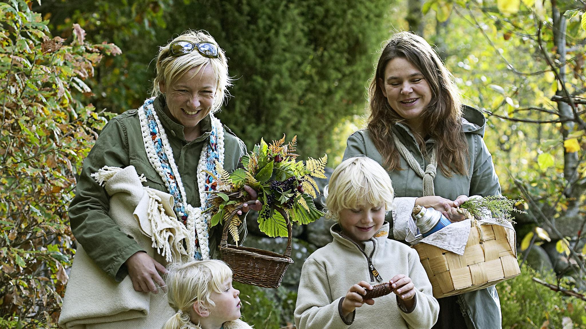 A family in the forest going mushroom hunting.