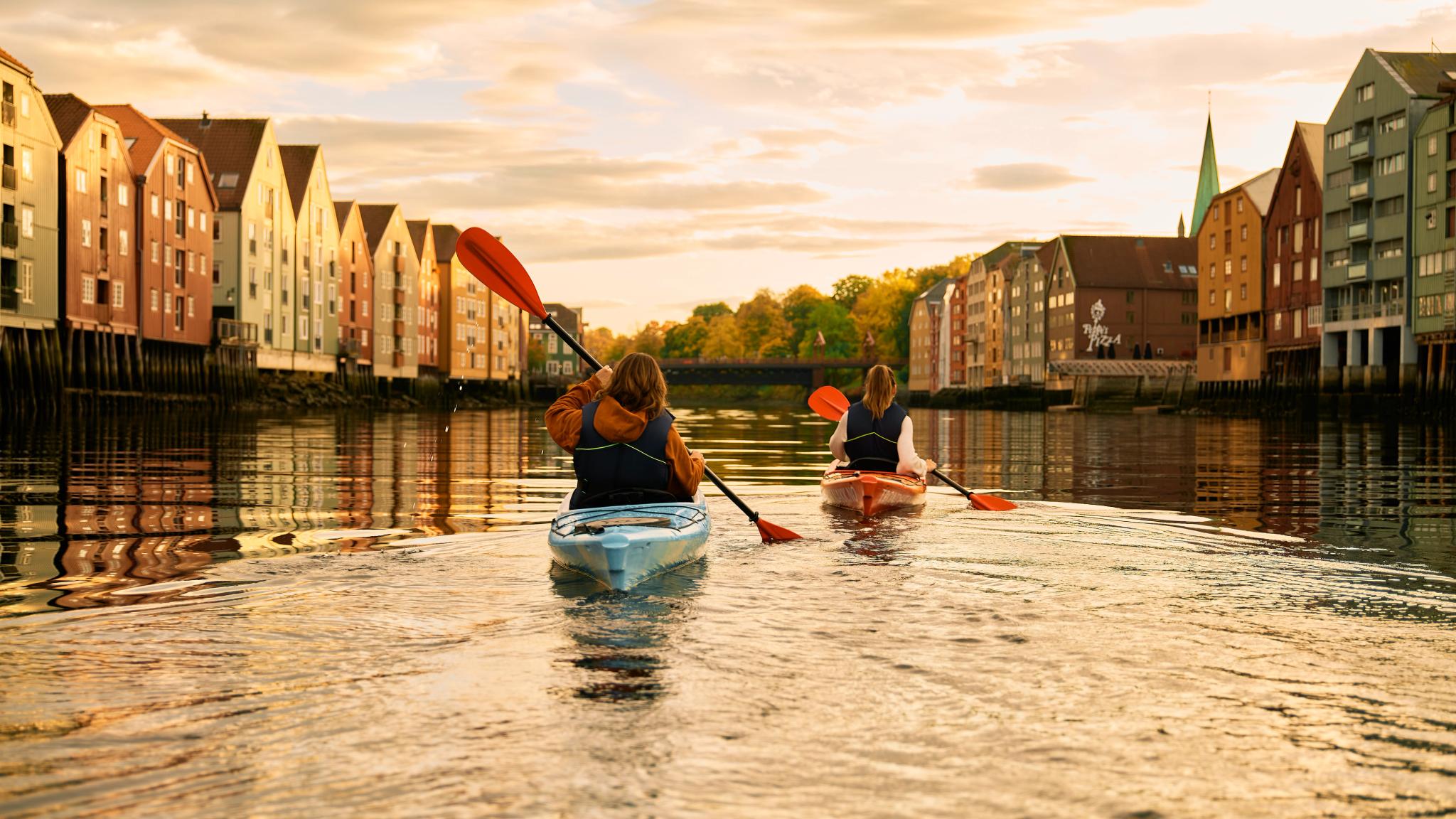 Kayaking in the sunset in the Nidelva river in Trondheim, Trøndelag