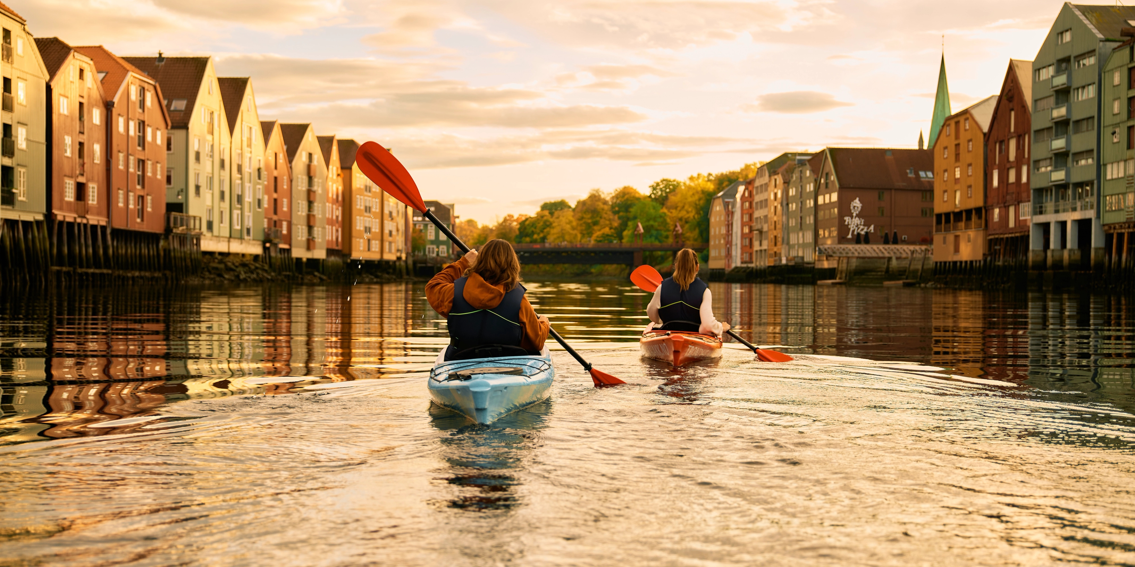 Kayaking in the sunset in the Nidelva river in Trondheim, Trøndelag