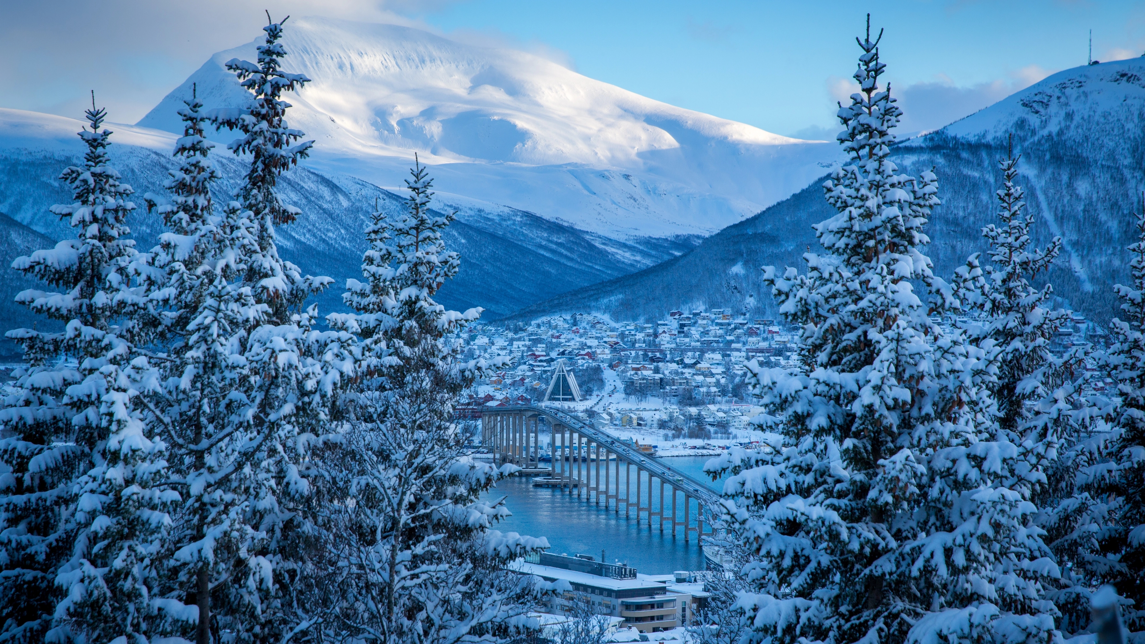 The Arctic Cathedral and the bridge in Tromsø covered in snow