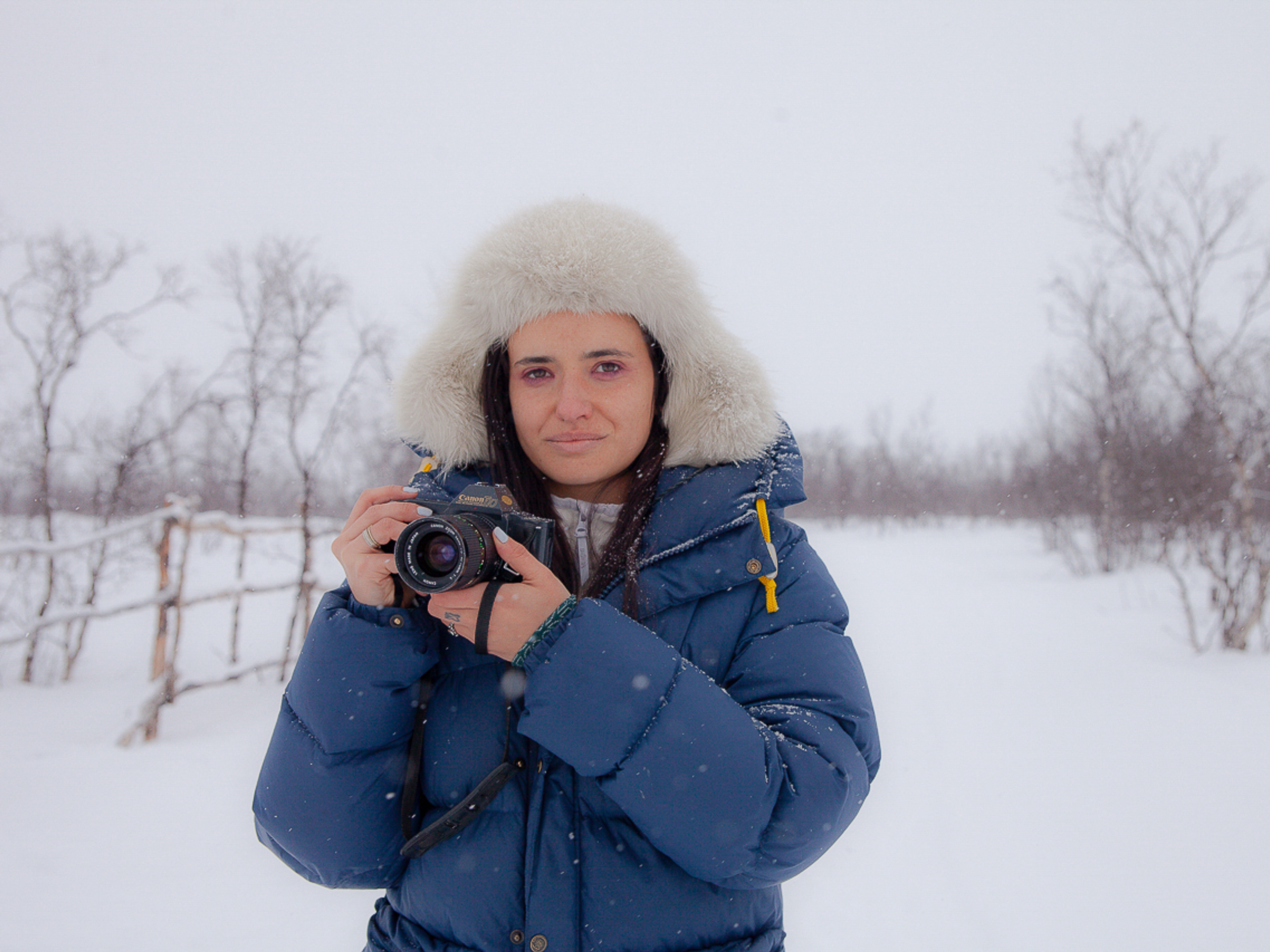 Italian woman with camera in the snow