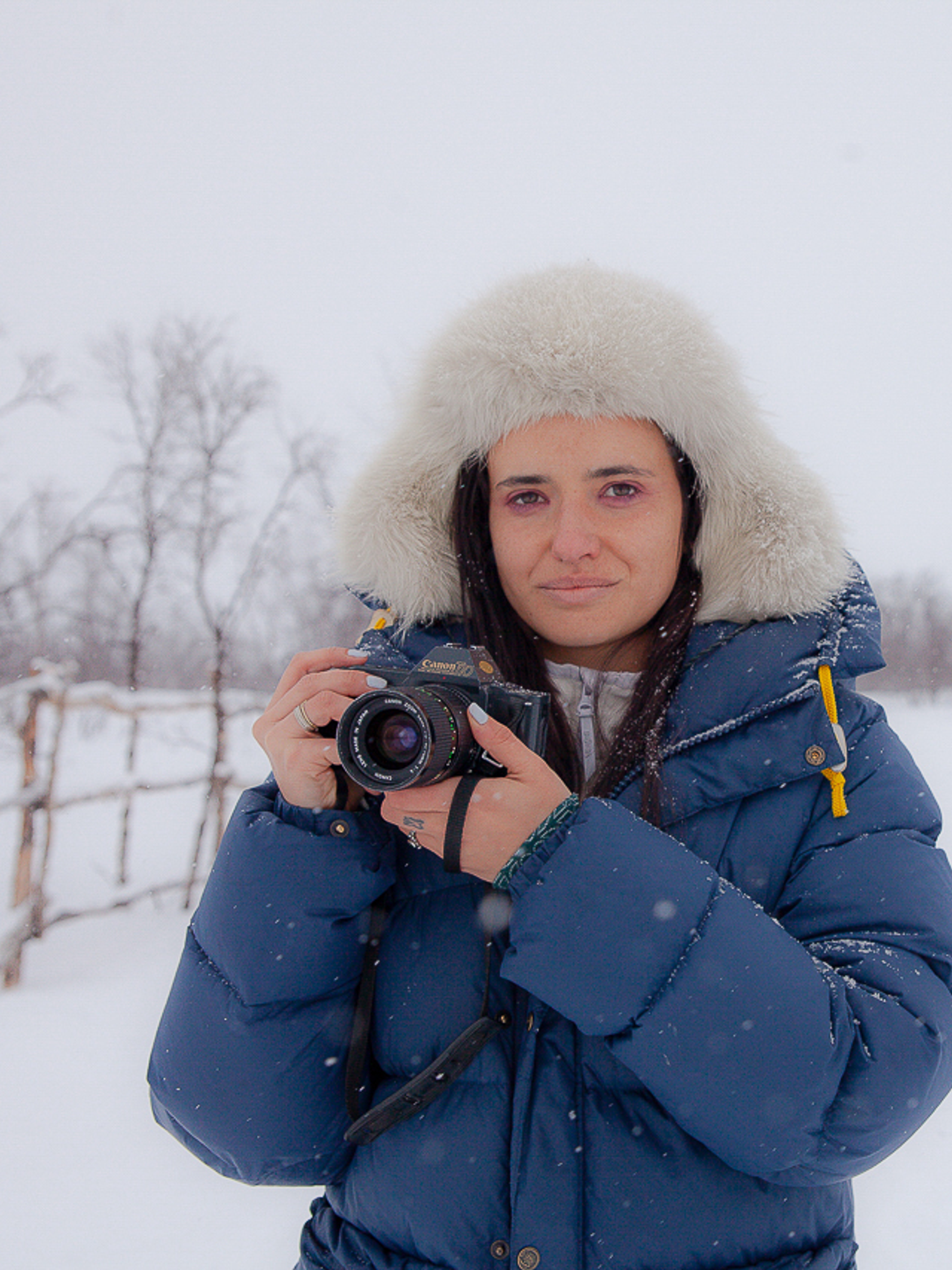 Italian woman with camera in the snow