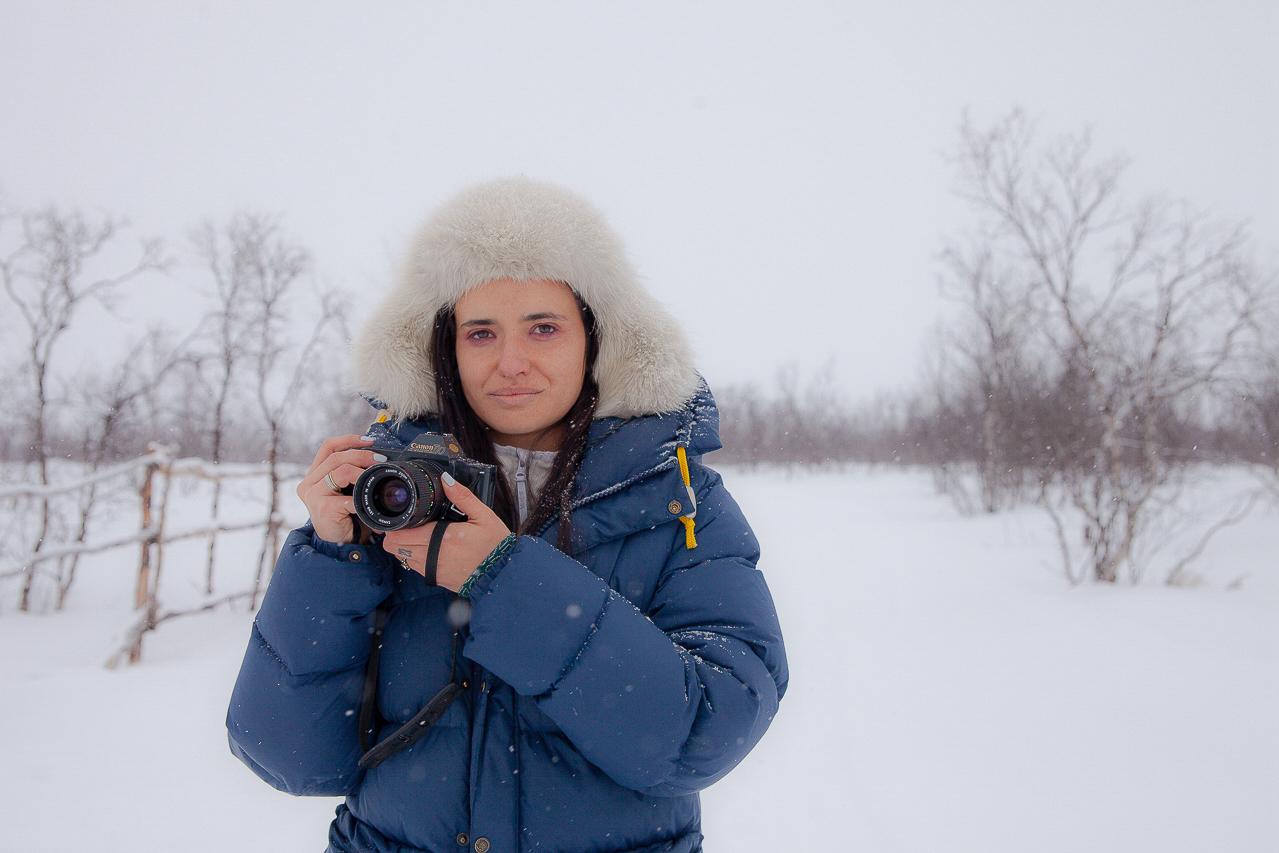 Italian woman with camera in the snow