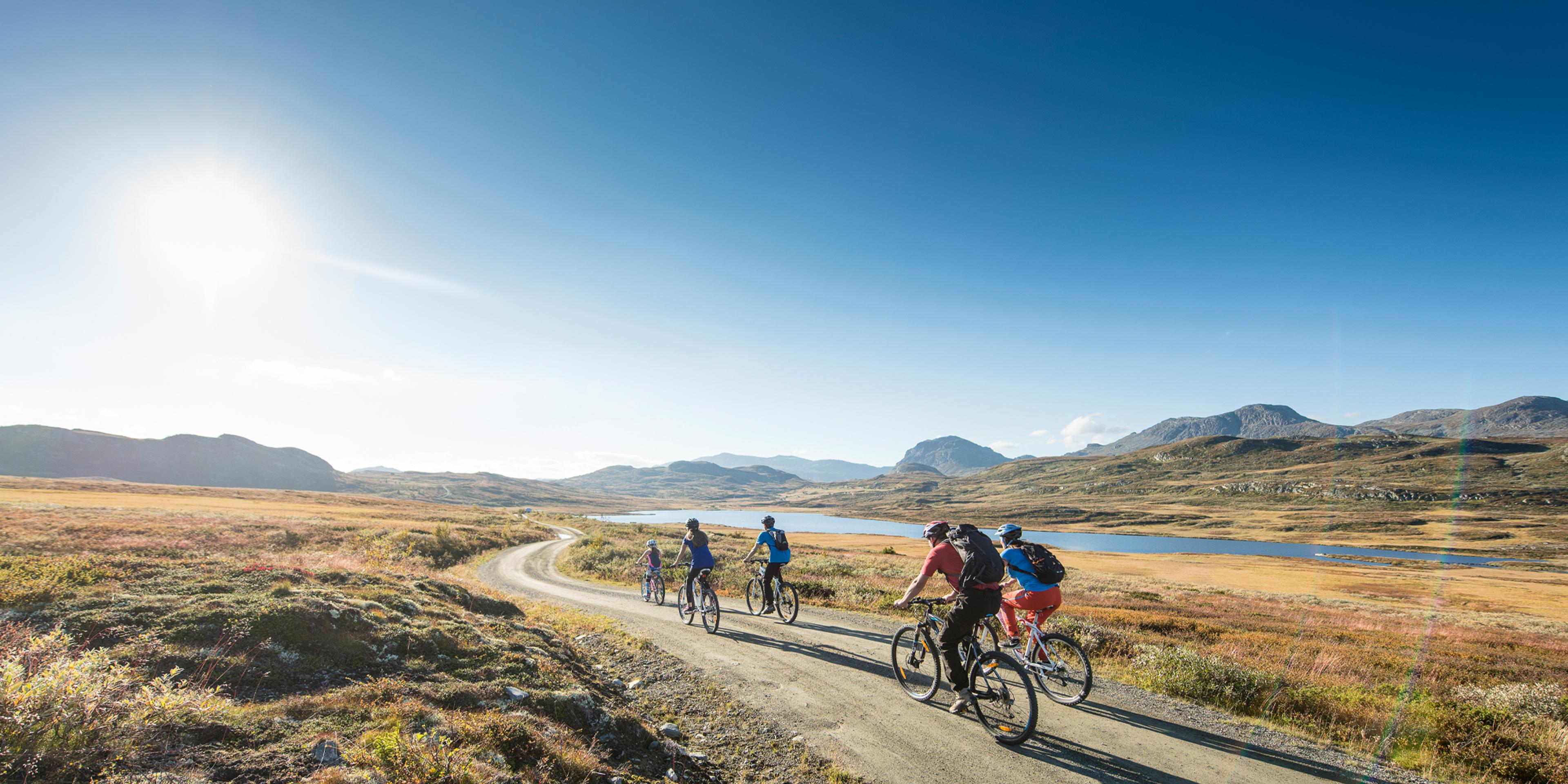 People biking on a gravel road in Ål in Hemsedal, Eastern Norway
