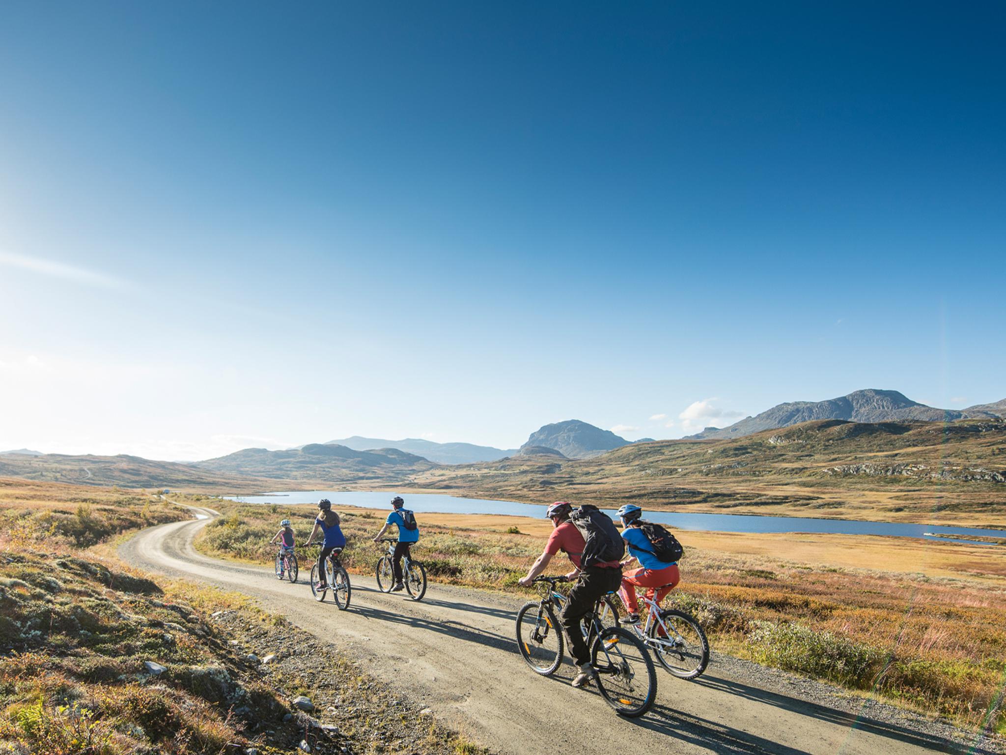 People biking on a gravel road in Ål in Hemsedal, Eastern Norway
