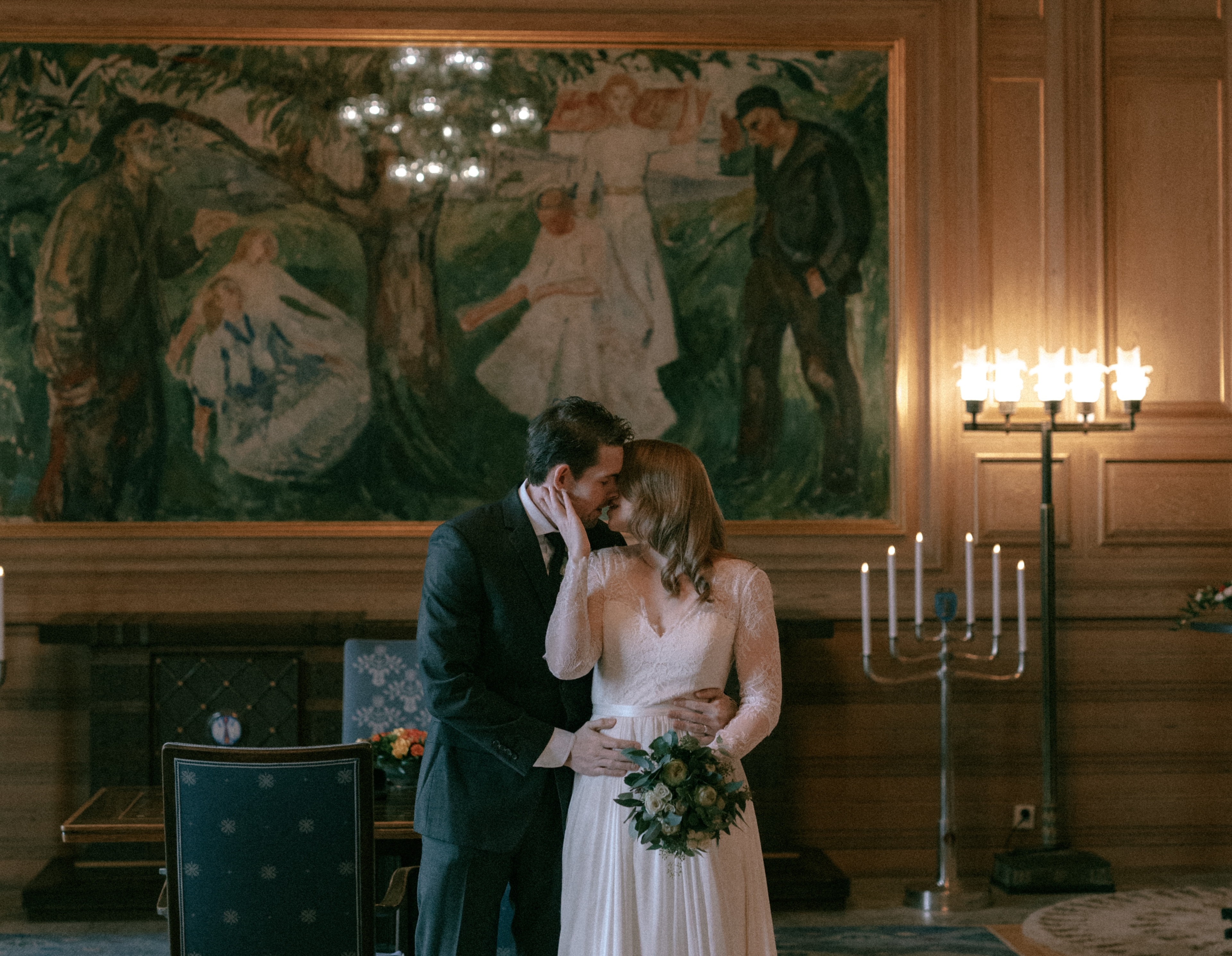 A wedding couple marrying in Oslo City Hall in front of Munch's painting "Life" in Oslo