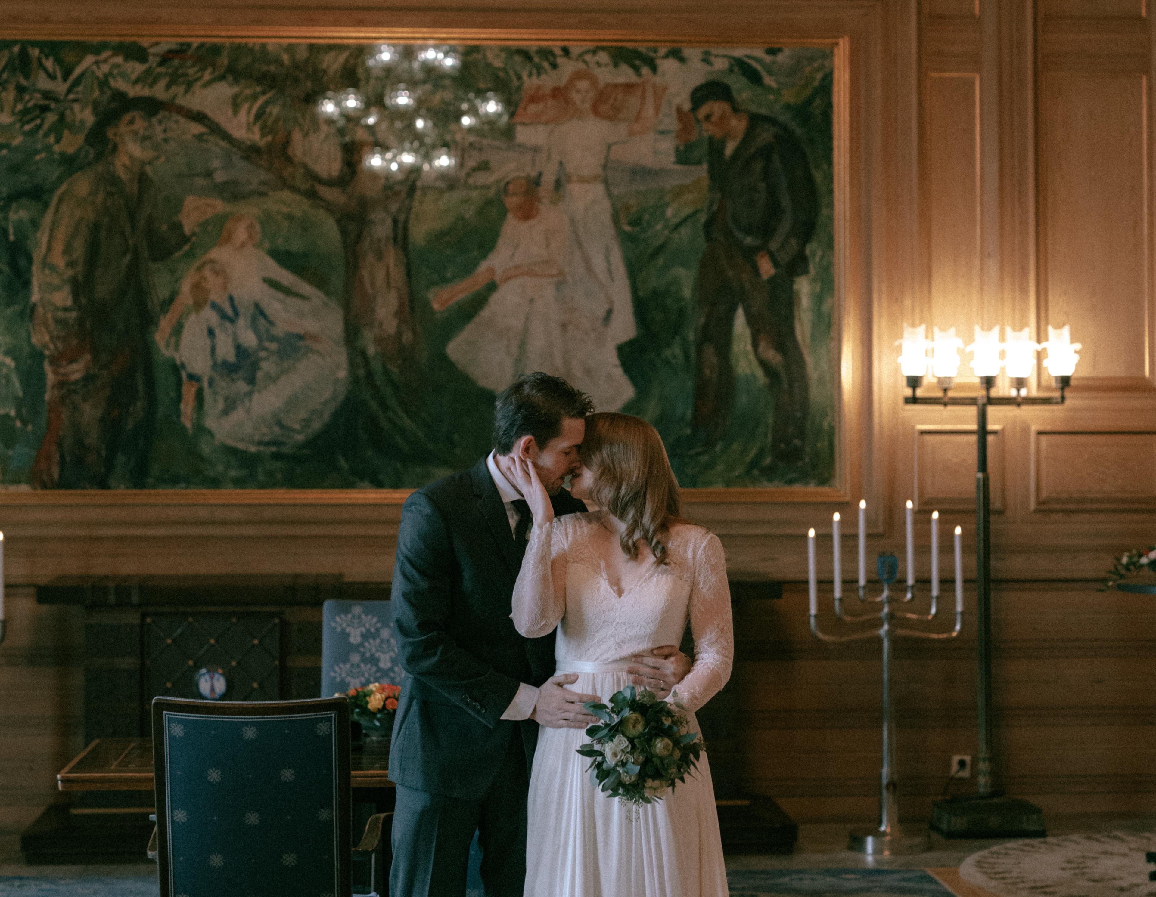 A wedding couple marrying in Oslo City Hall in front of Munch's painting "Life" in Oslo