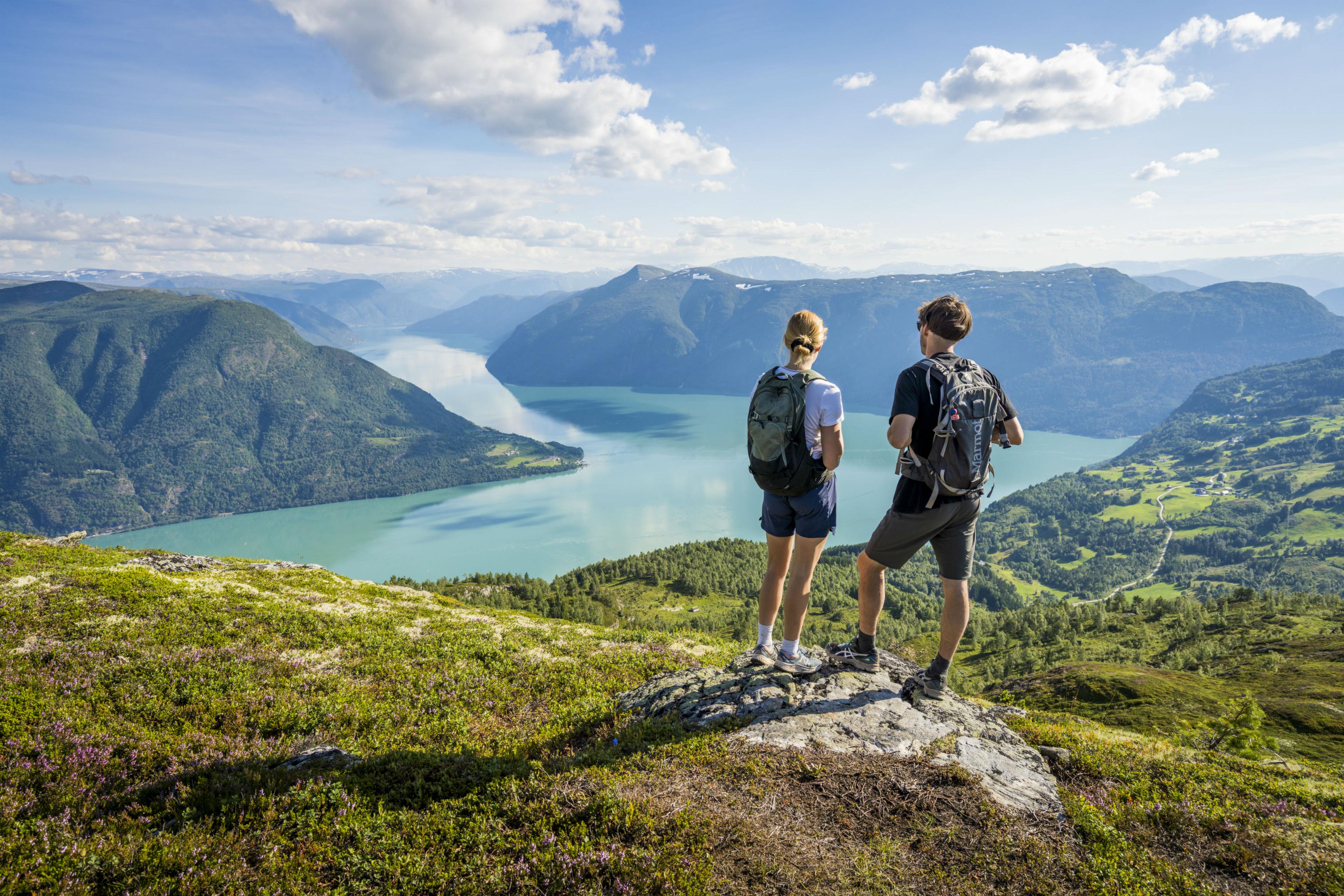 Two people admiring the view from the top of mount Molden in the Sognefjord area of Fjord Norway