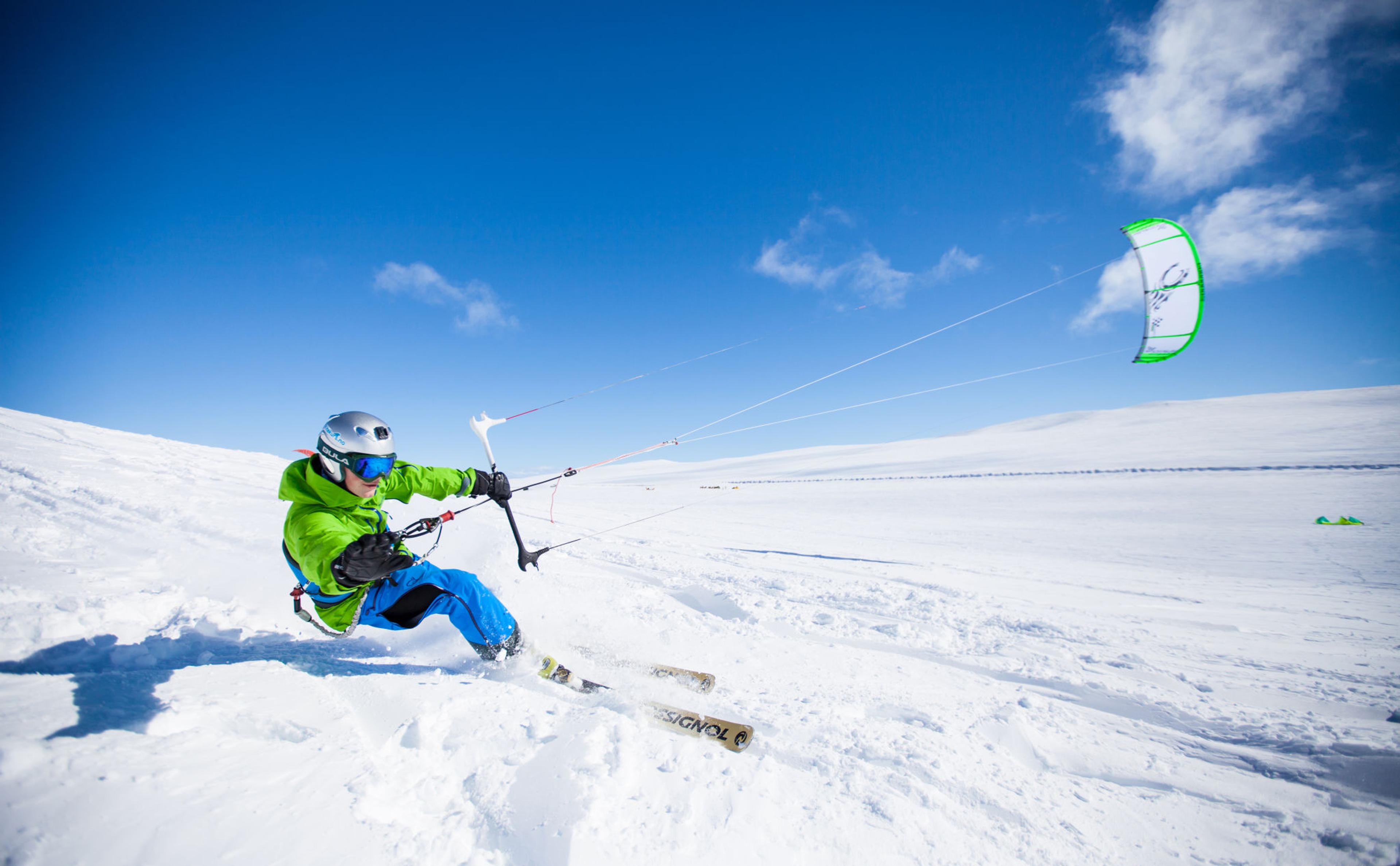 A man snowkiting on the Valdresflye mountain plateau in Jotunheimen, Eastern Norway