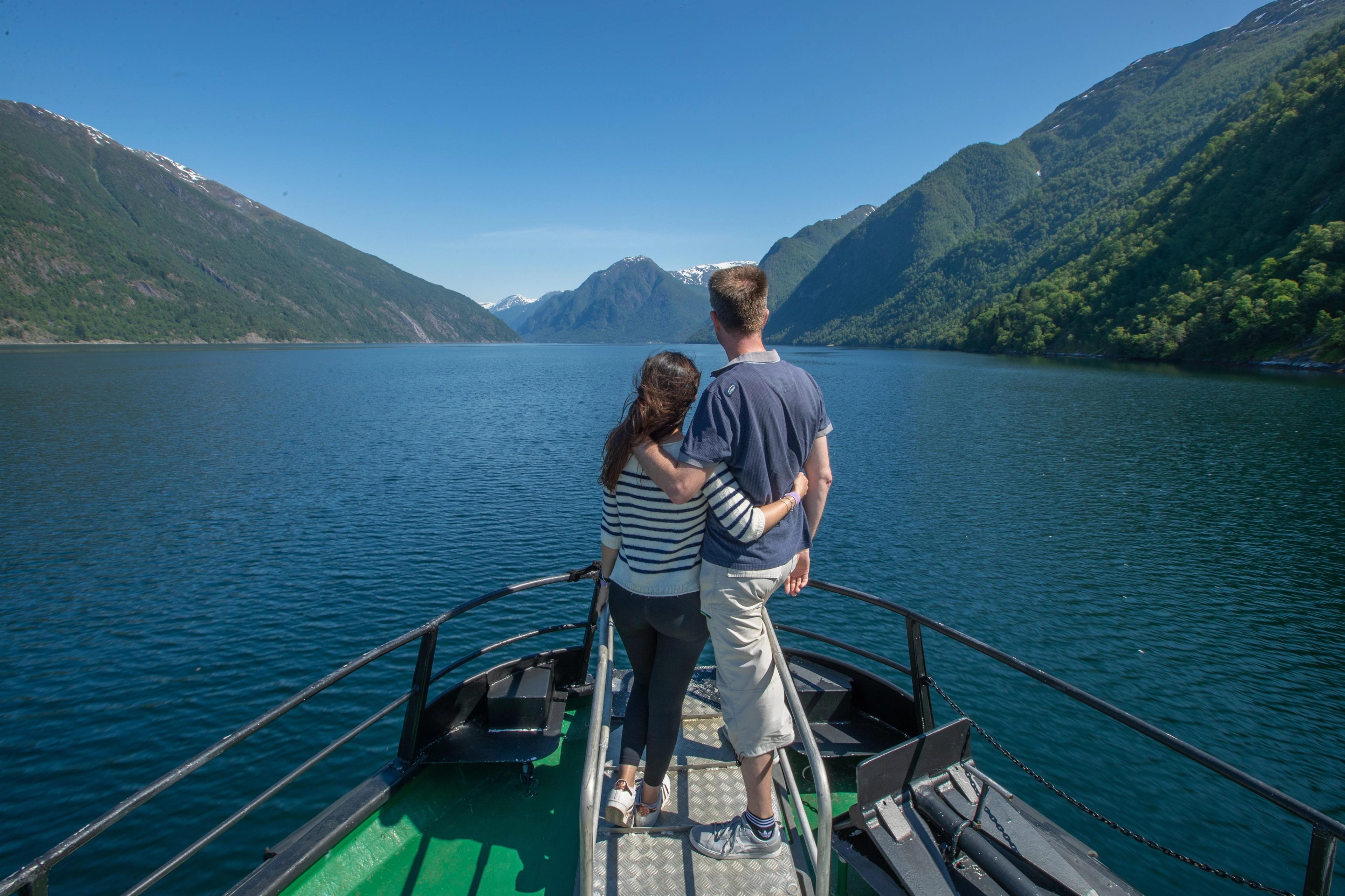 A couple enjoying the breathtaking fjord landscape from a boat