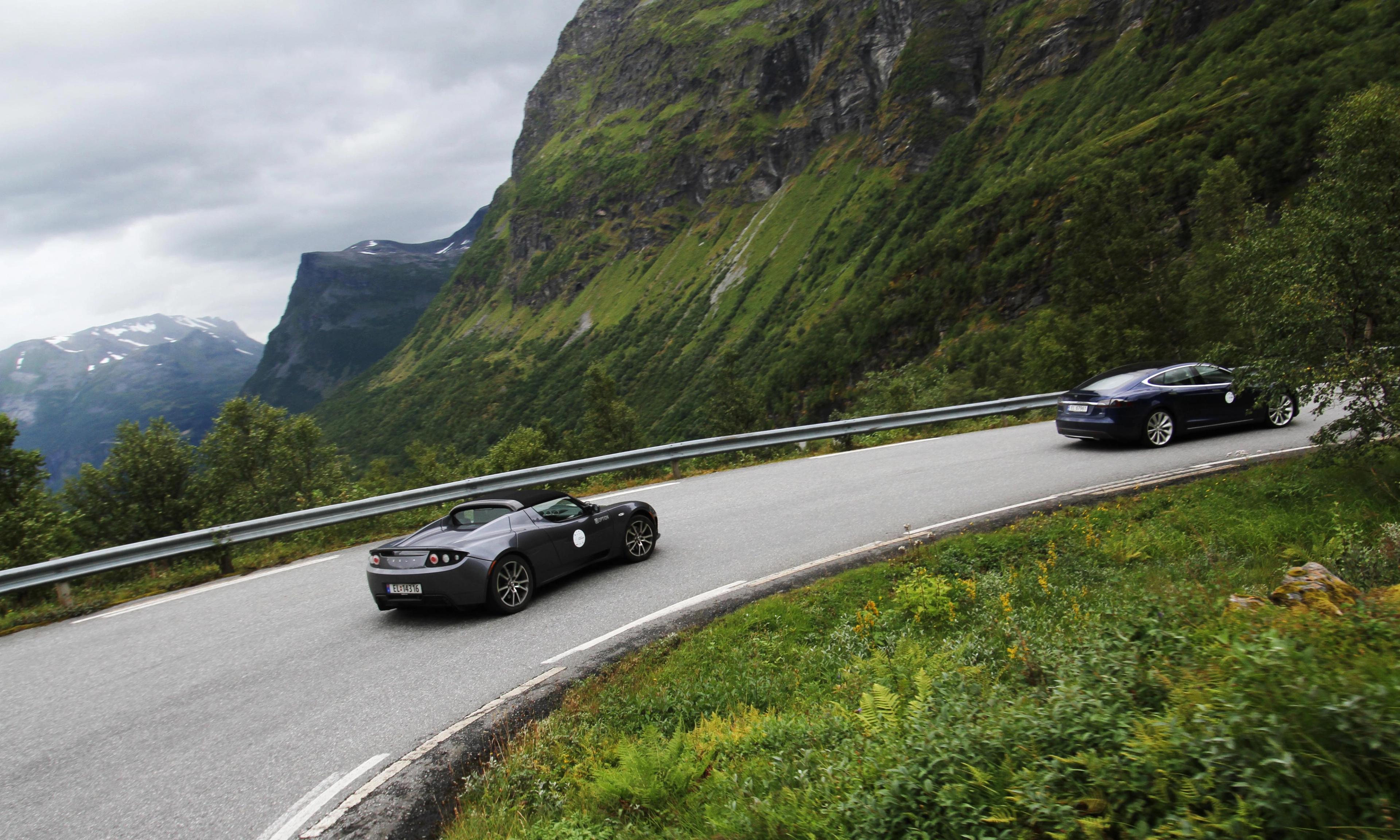 Two electric cars on the road in Geiranger.