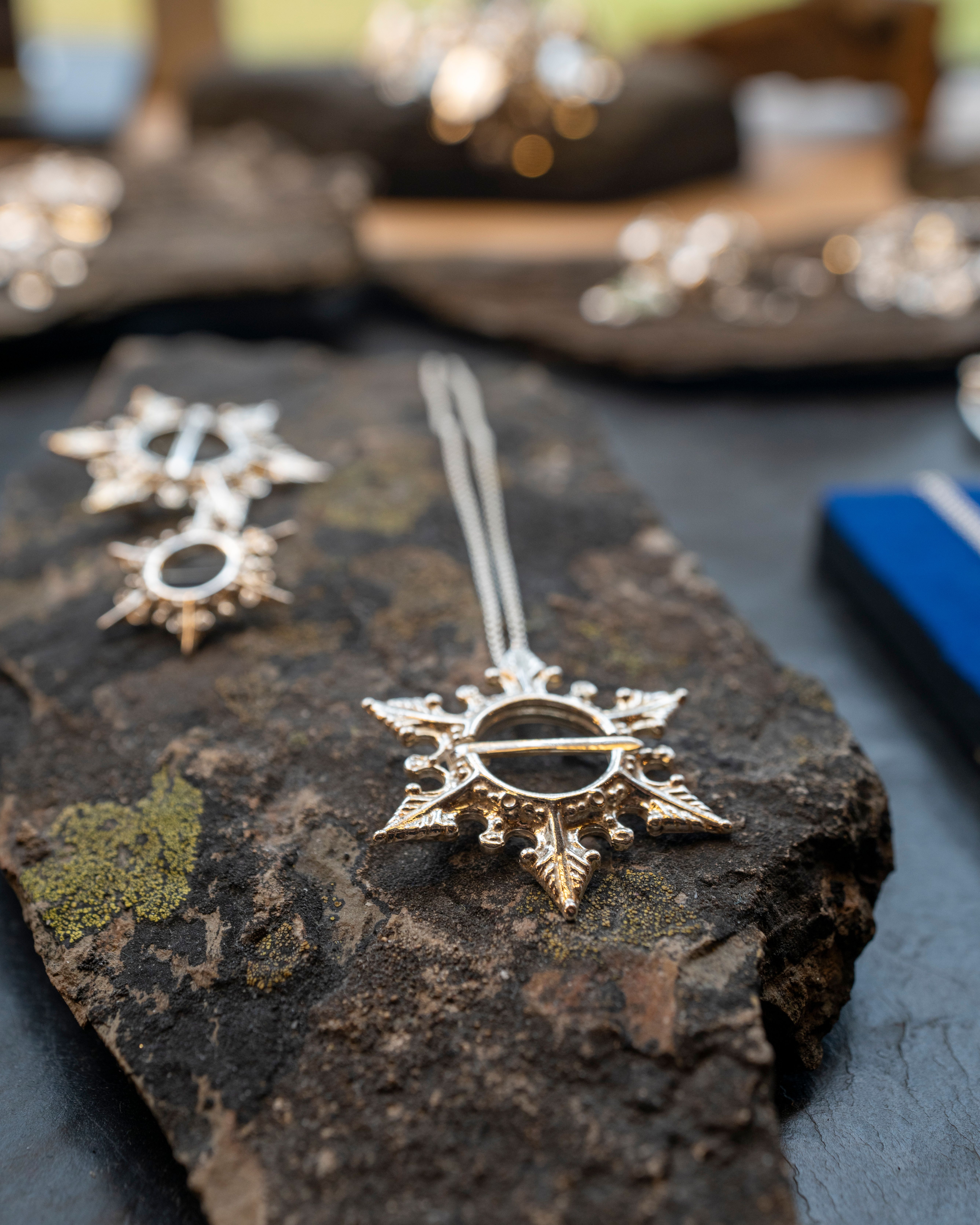 Silver necklaces on a rock in Juhls Silver Gallery