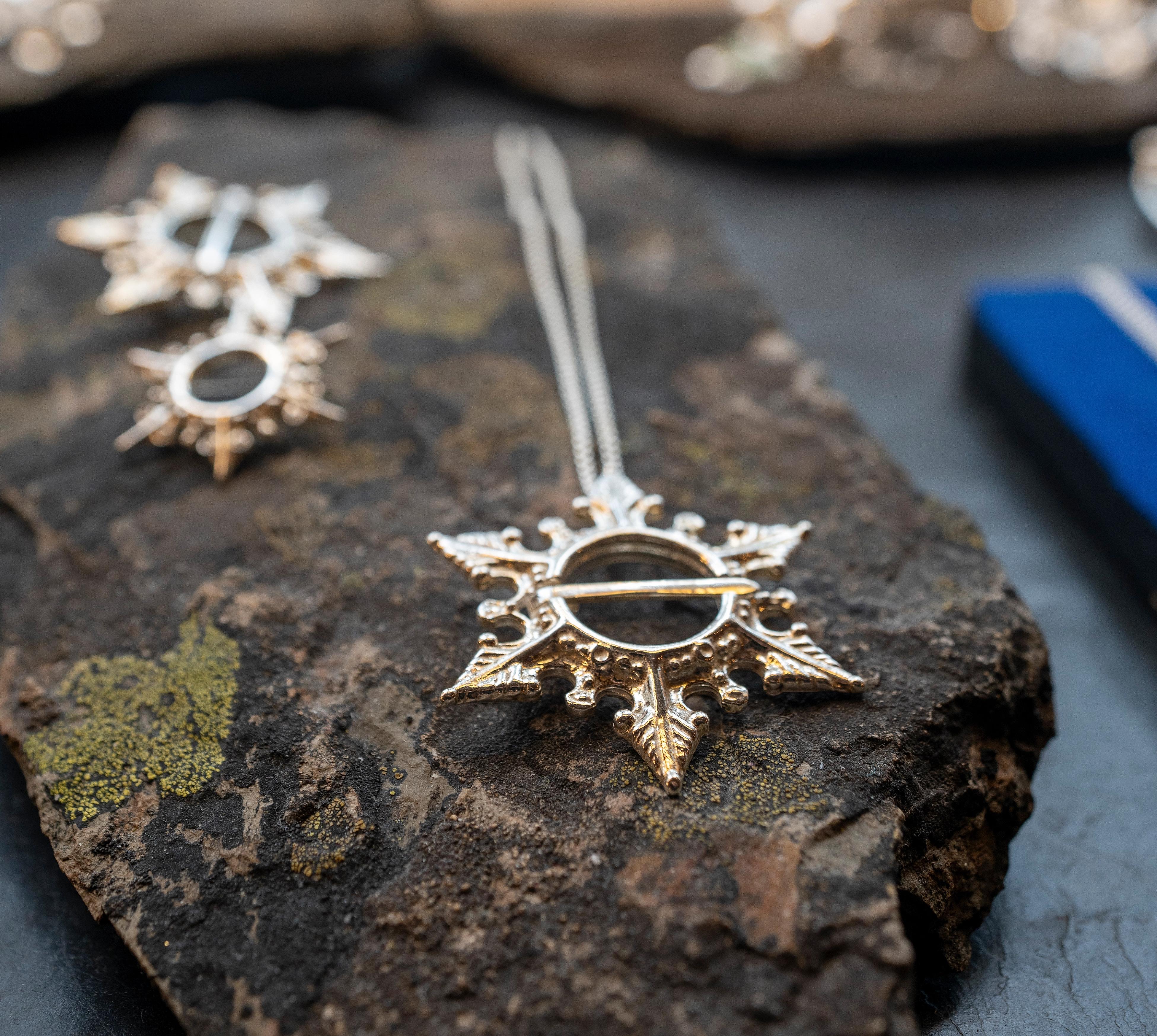 Silver necklaces on a rock in Juhls Silver Gallery