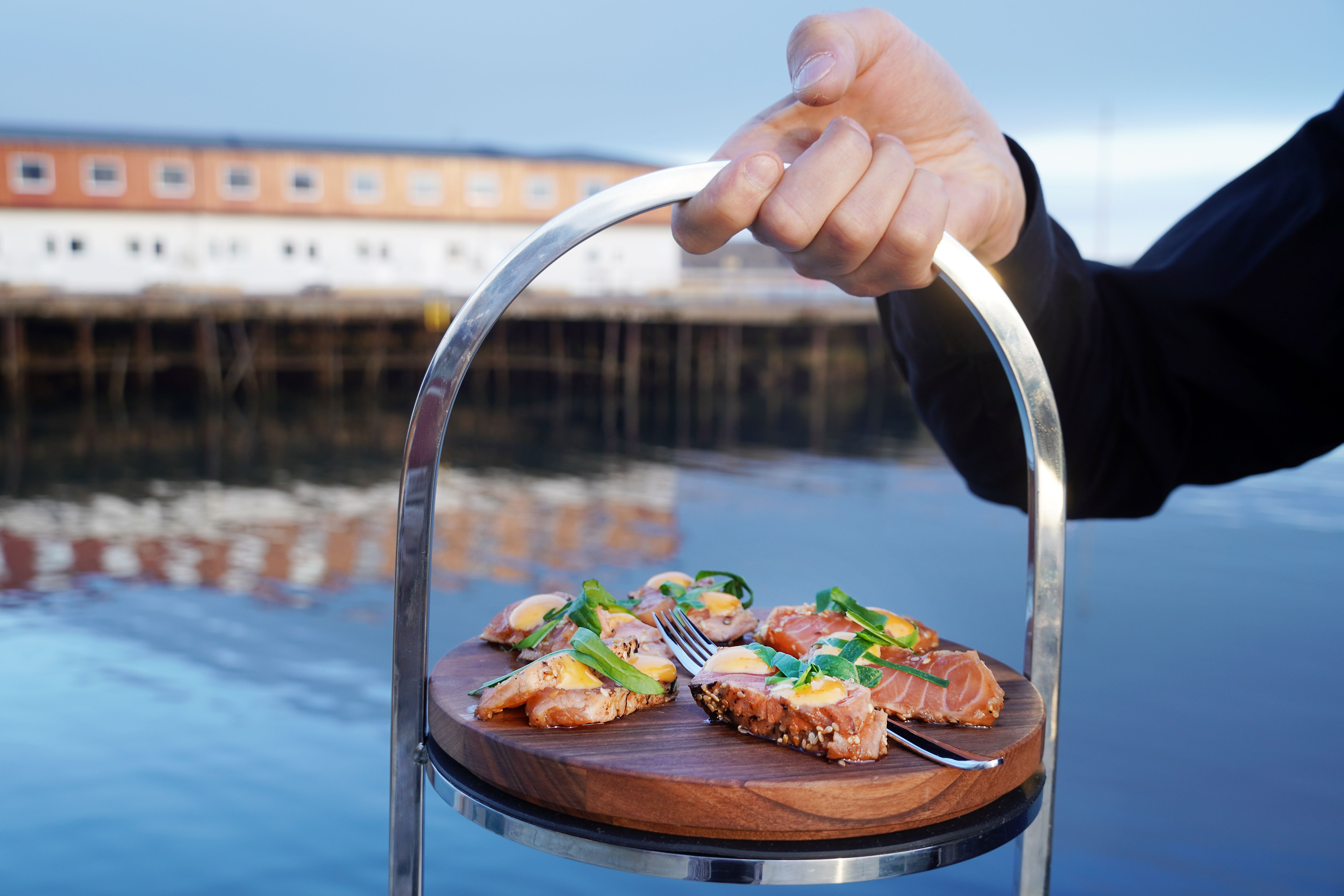 Salmon on a plate in front of the sea in Lofoten