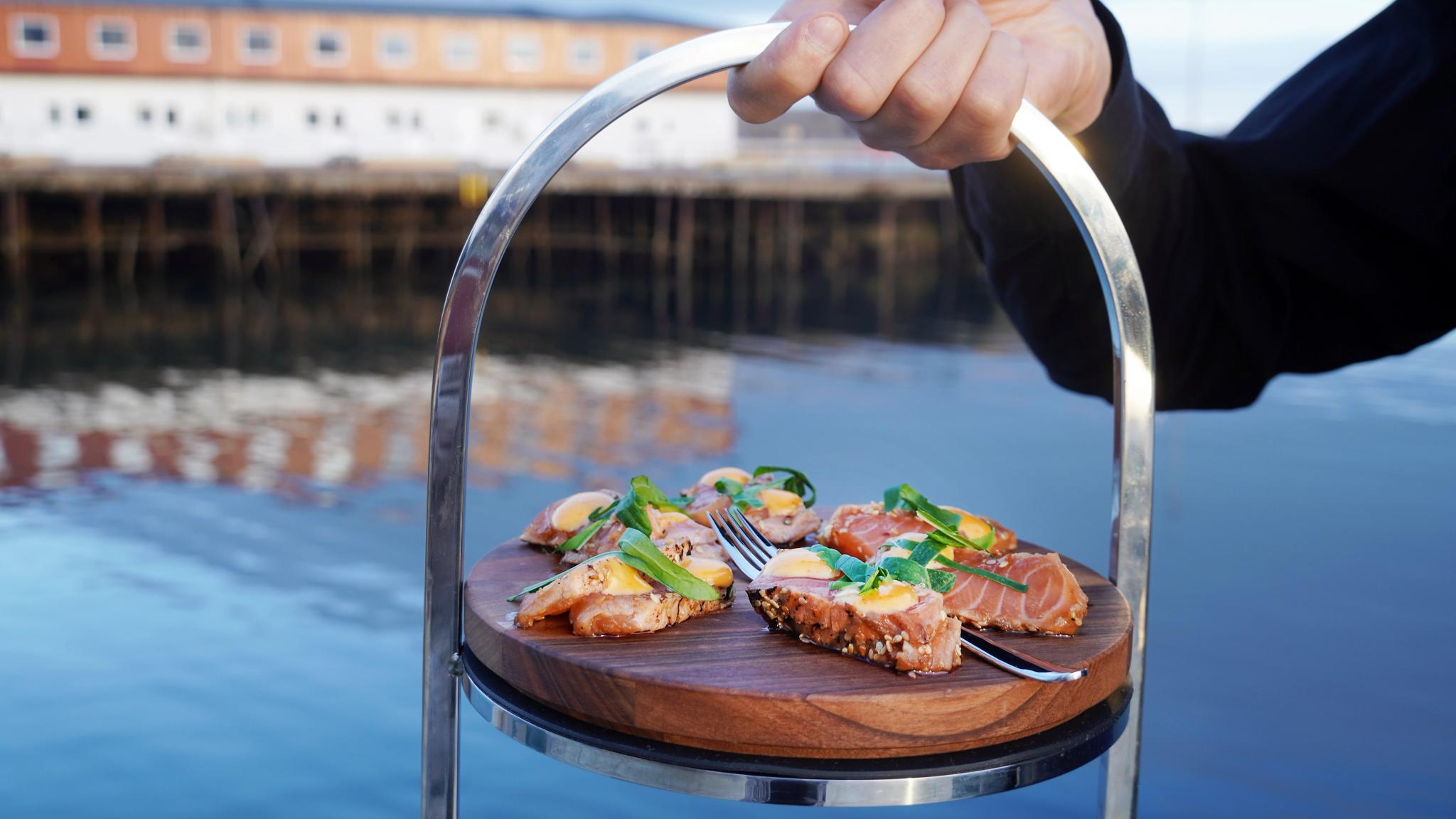 Salmon on a plate in front of the sea in Lofoten