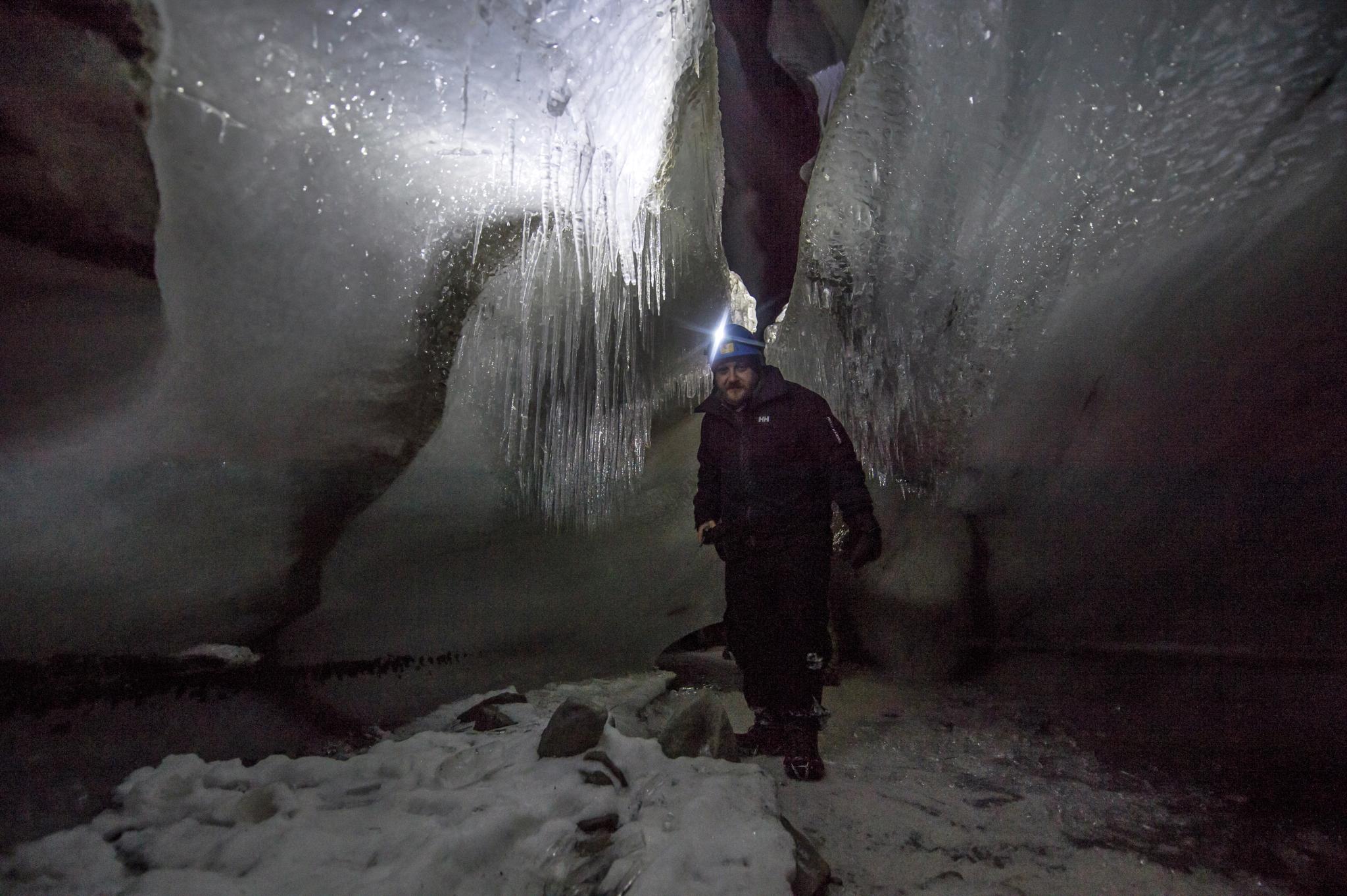 A man inside an ice cave