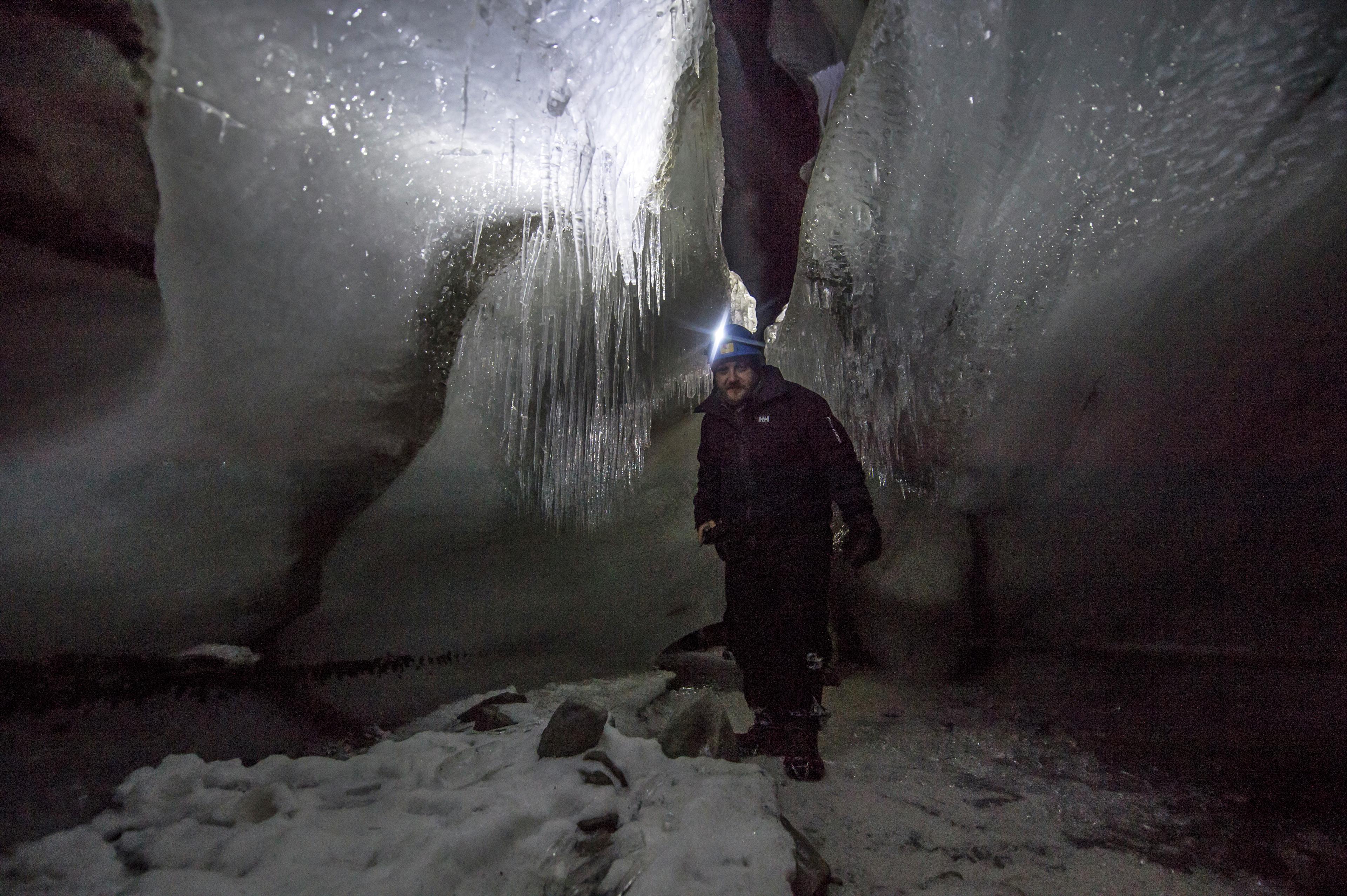 A man inside an ice cave
