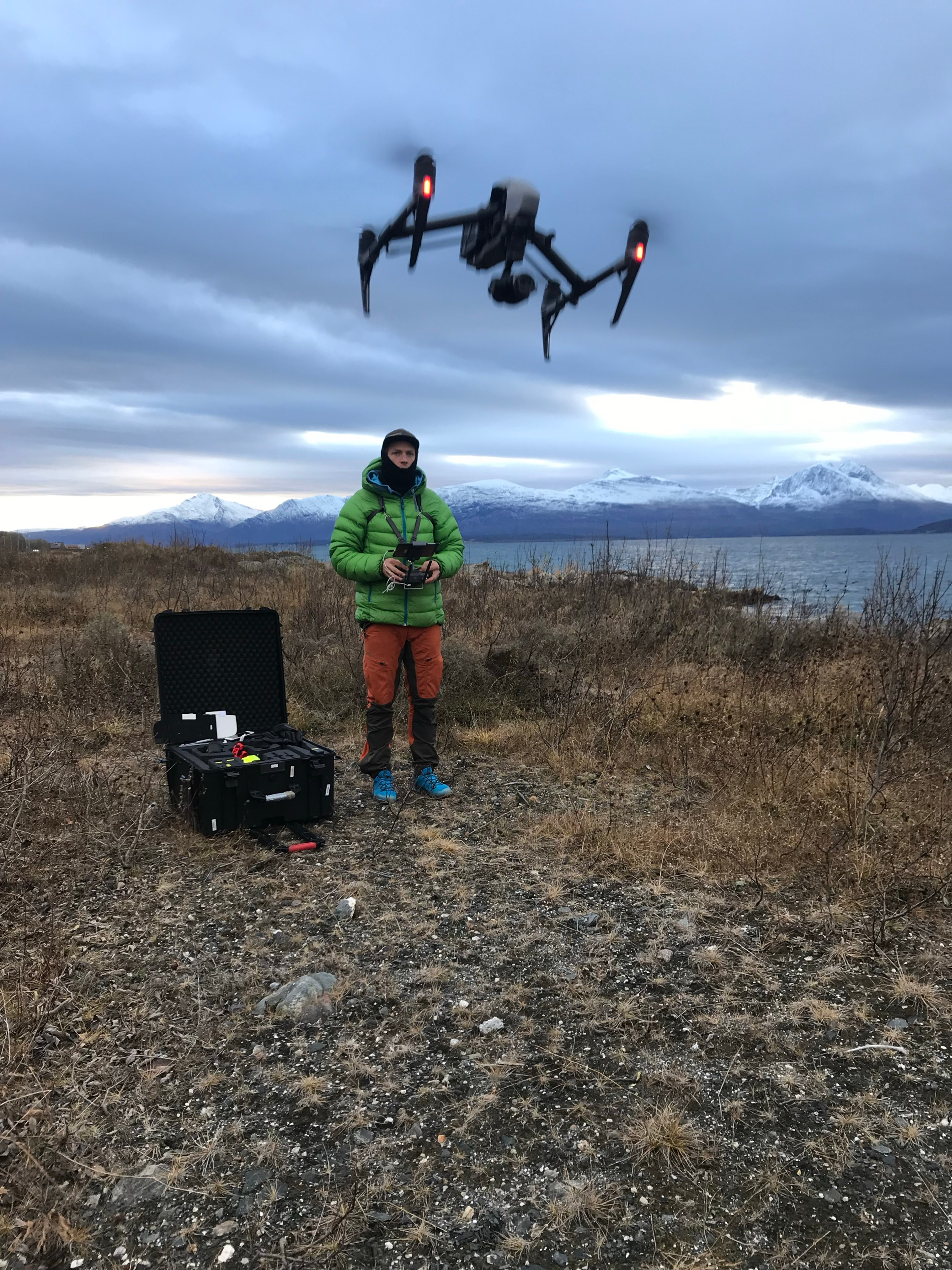 Man flying a drone in nature