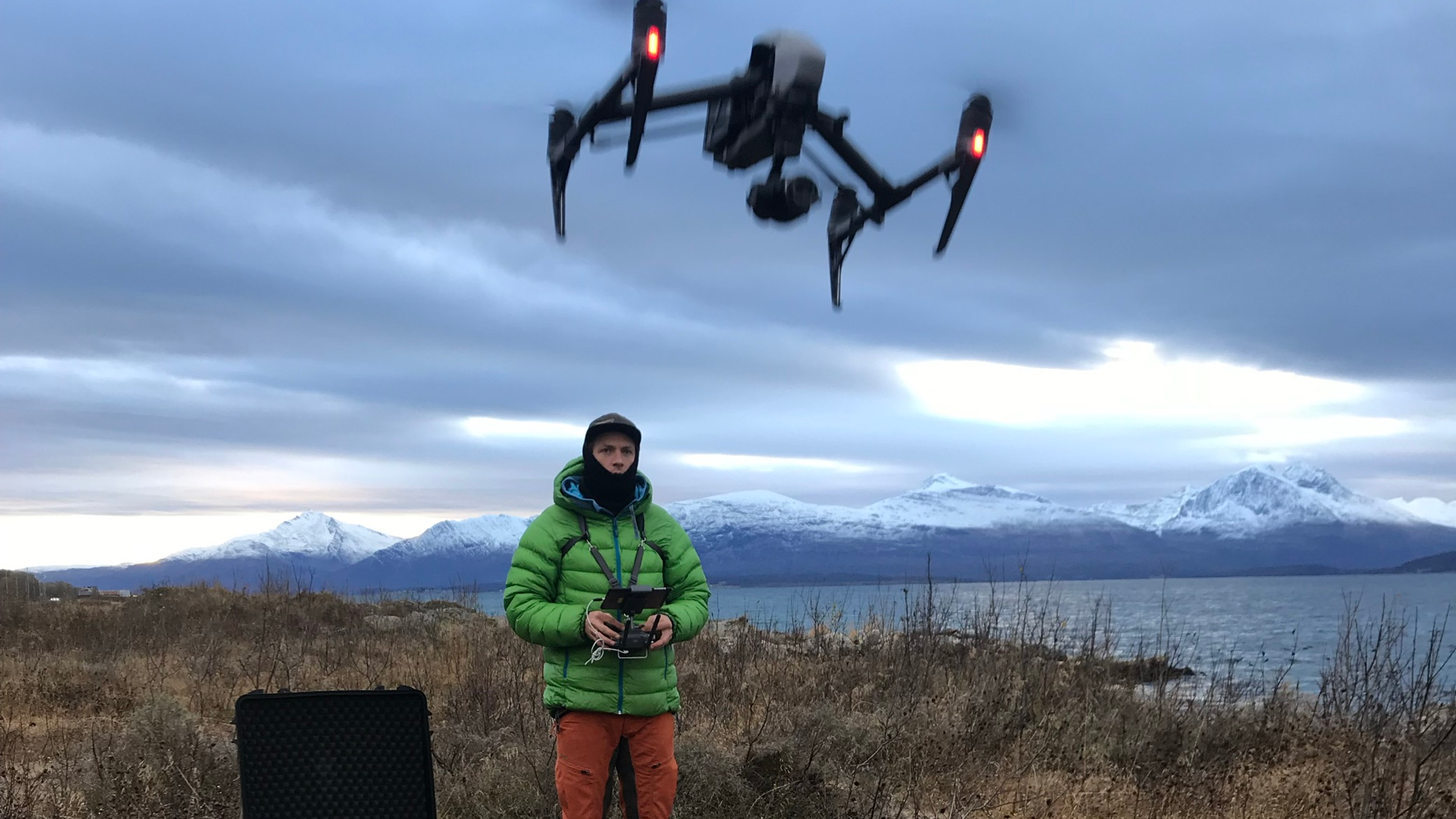 Man flying a drone in nature