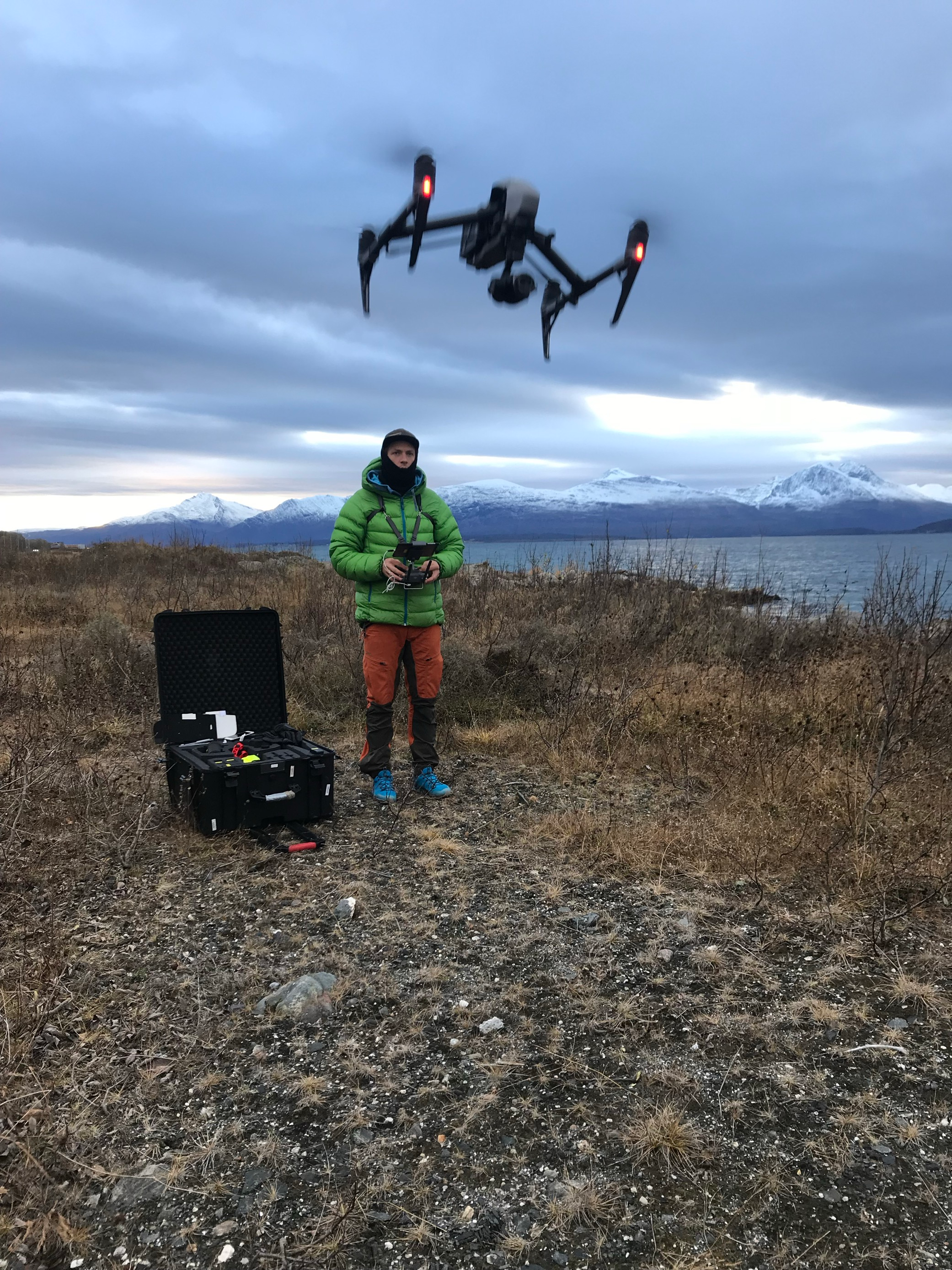 Man flying a drone in nature