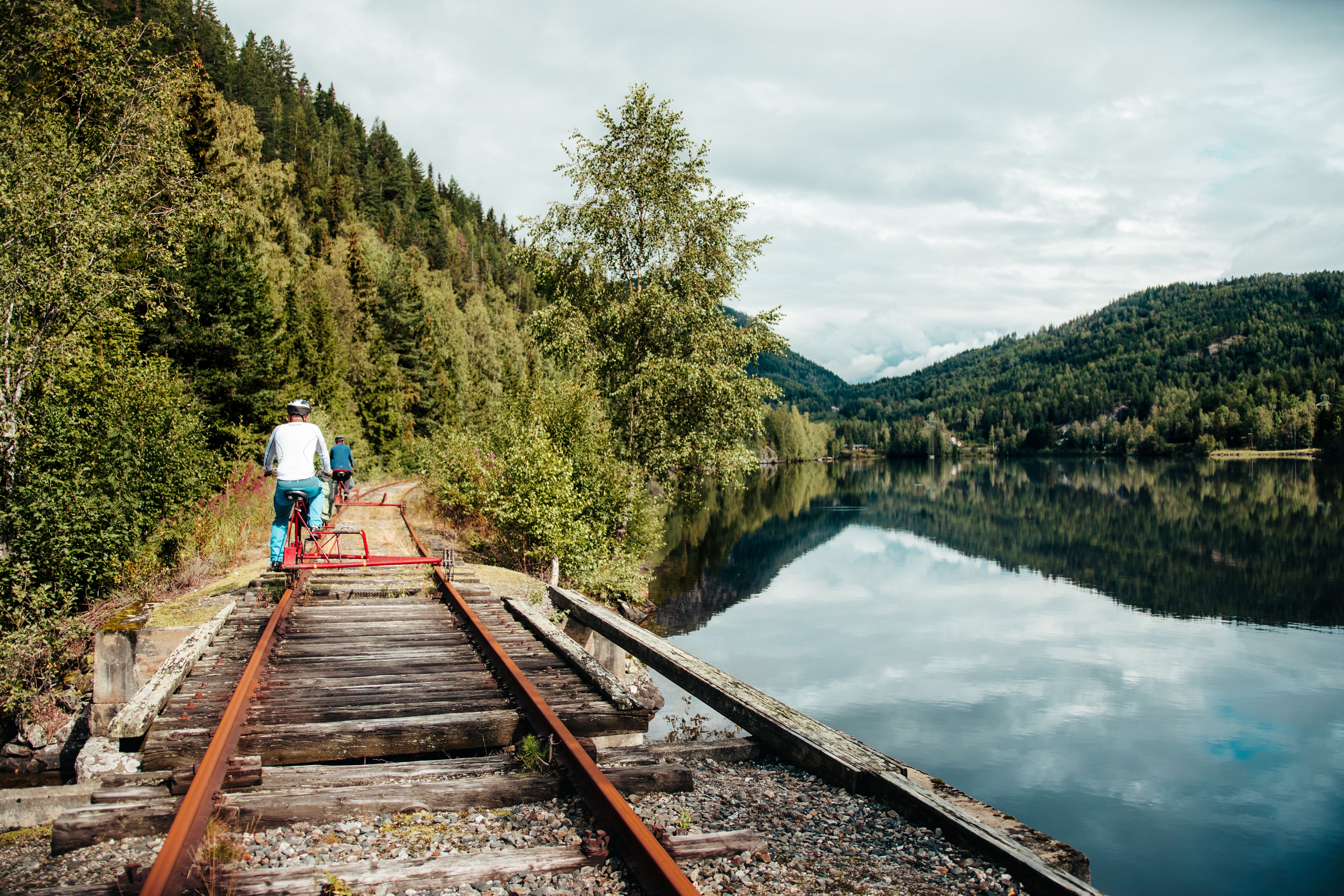 A man is rail tricycling by a lake in Veggli in Numedal, Eastern Norway