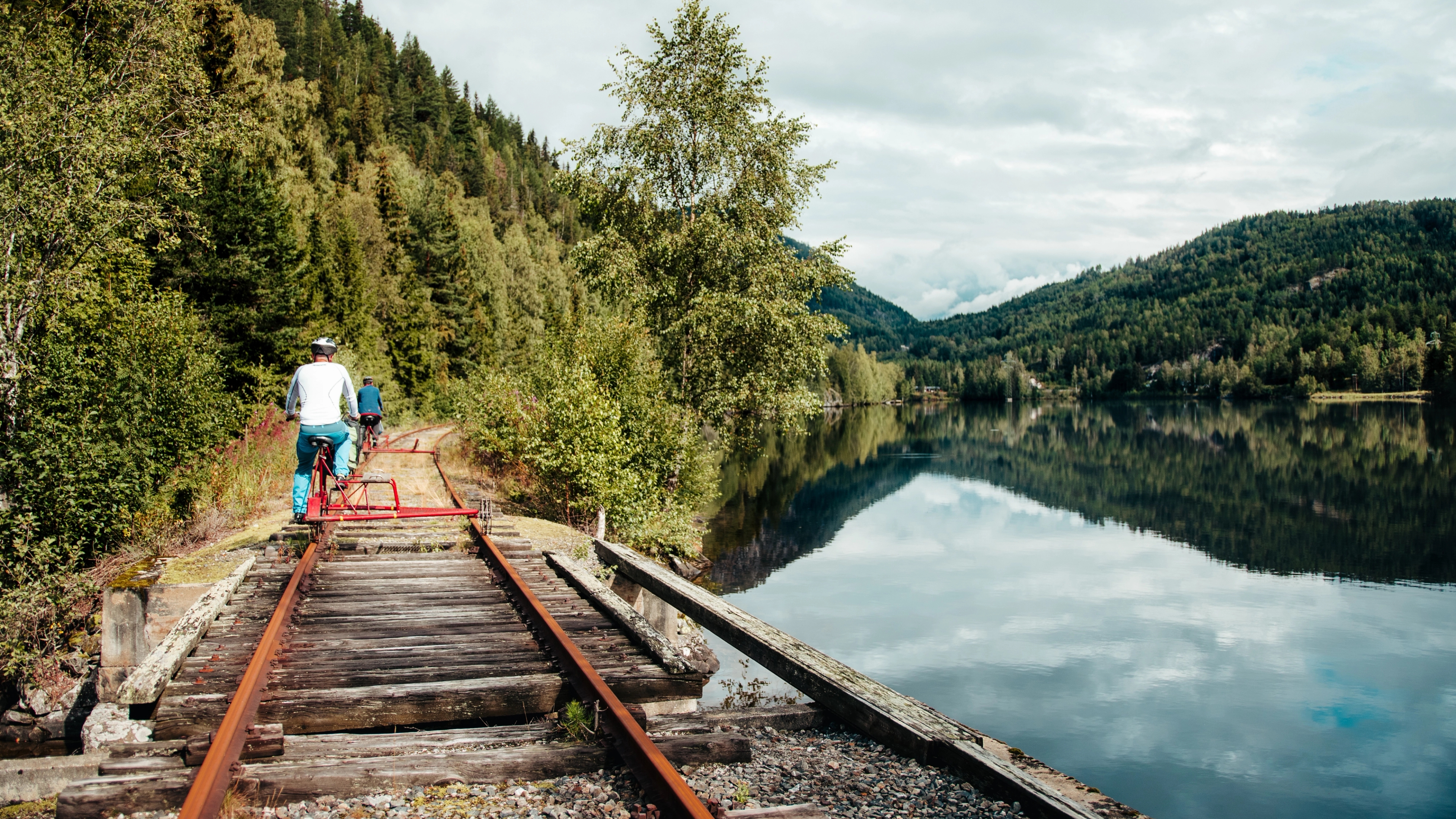 A man is rail tricycling by a lake in Veggli in Numedal, Eastern Norway