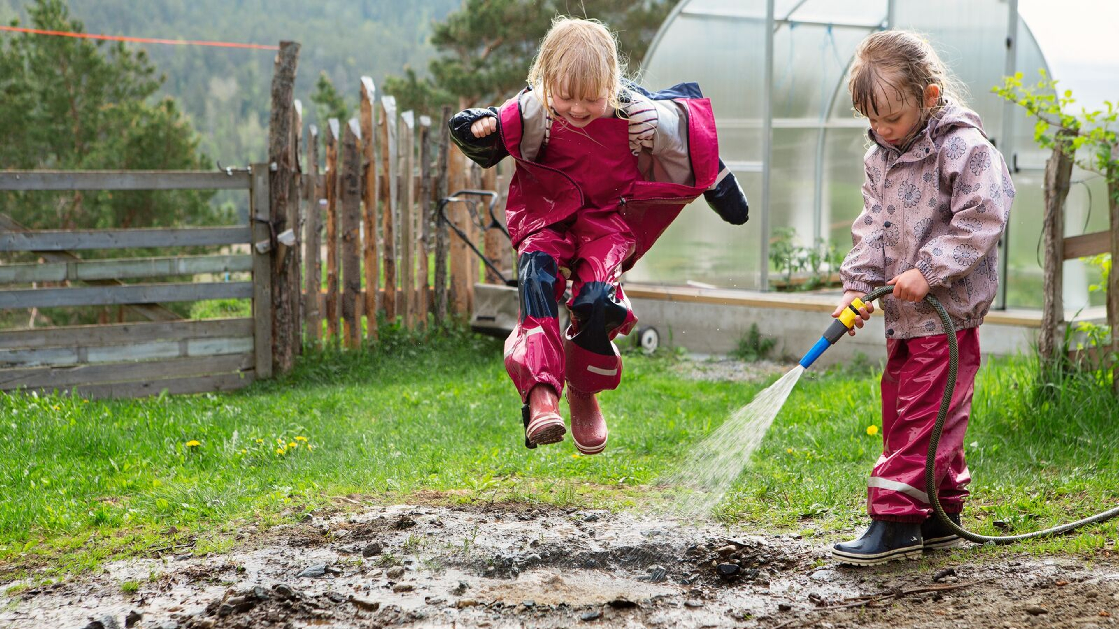 Children playing outside of a farm, Norway