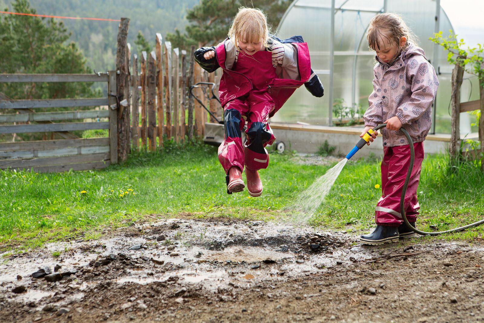 Children playing outside of a farm, Norway
