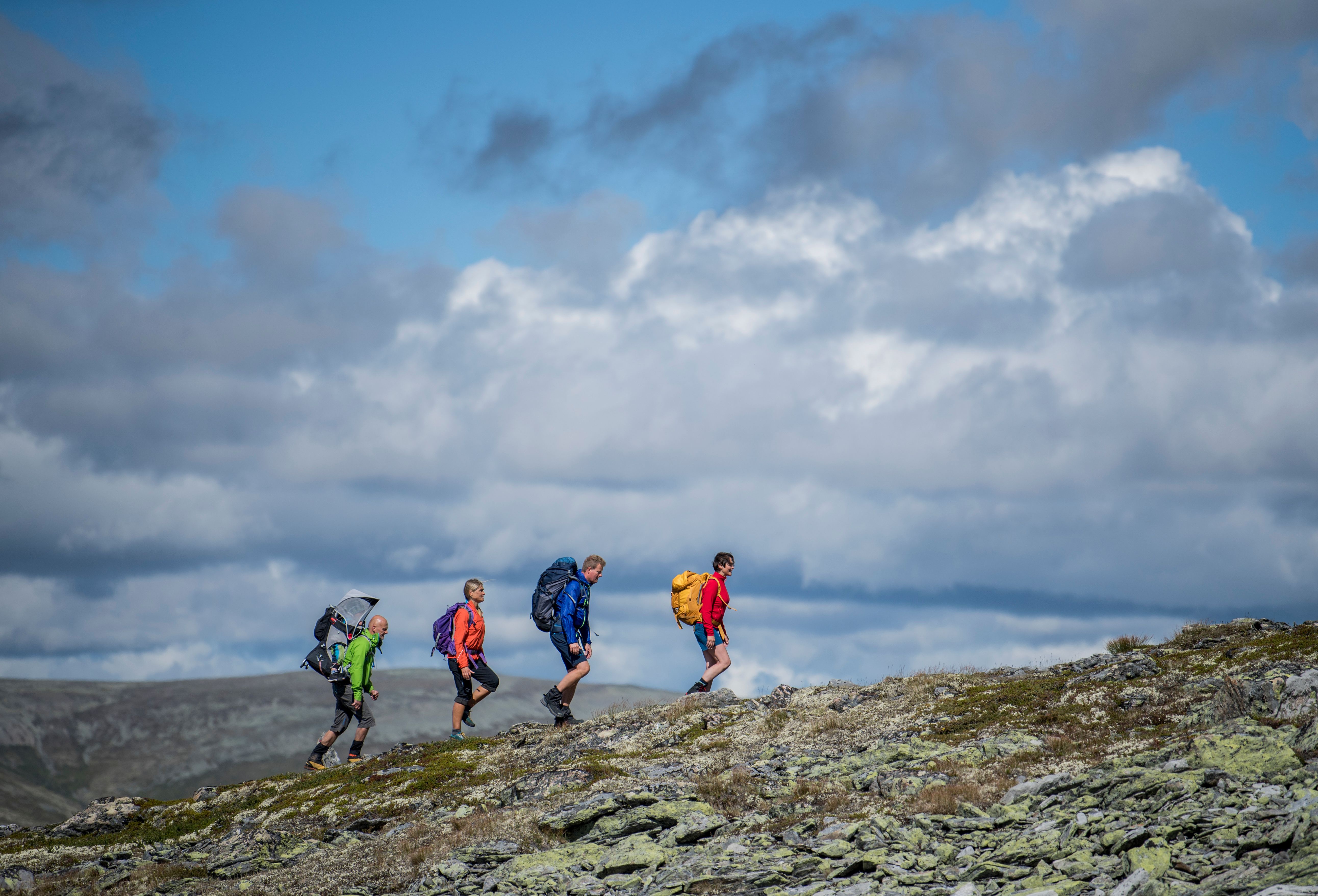 A group of people hiking up Høvringen in Rondane, Eastern Norway.