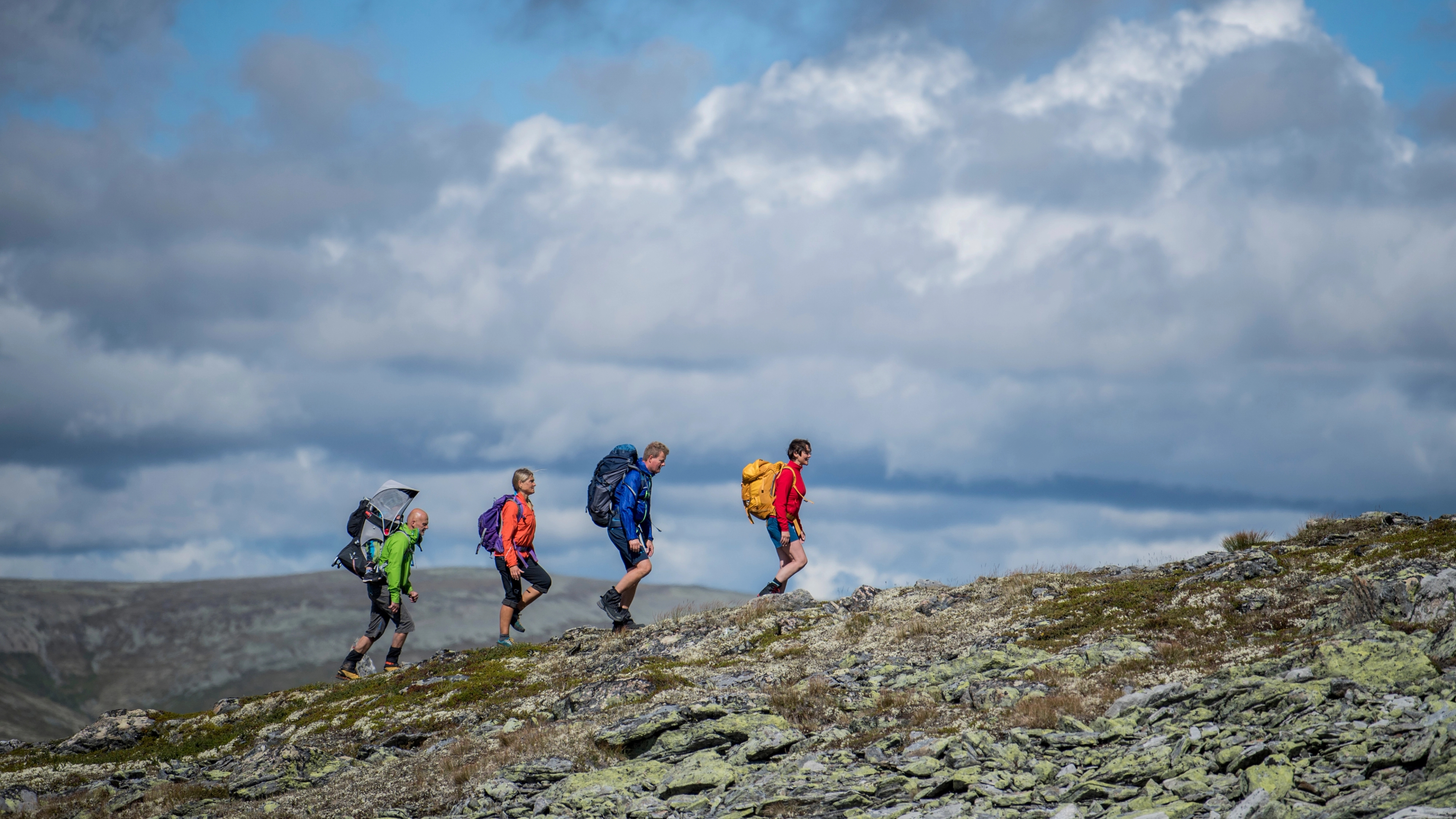 A group of people hiking up Høvringen in Rondane, Eastern Norway.