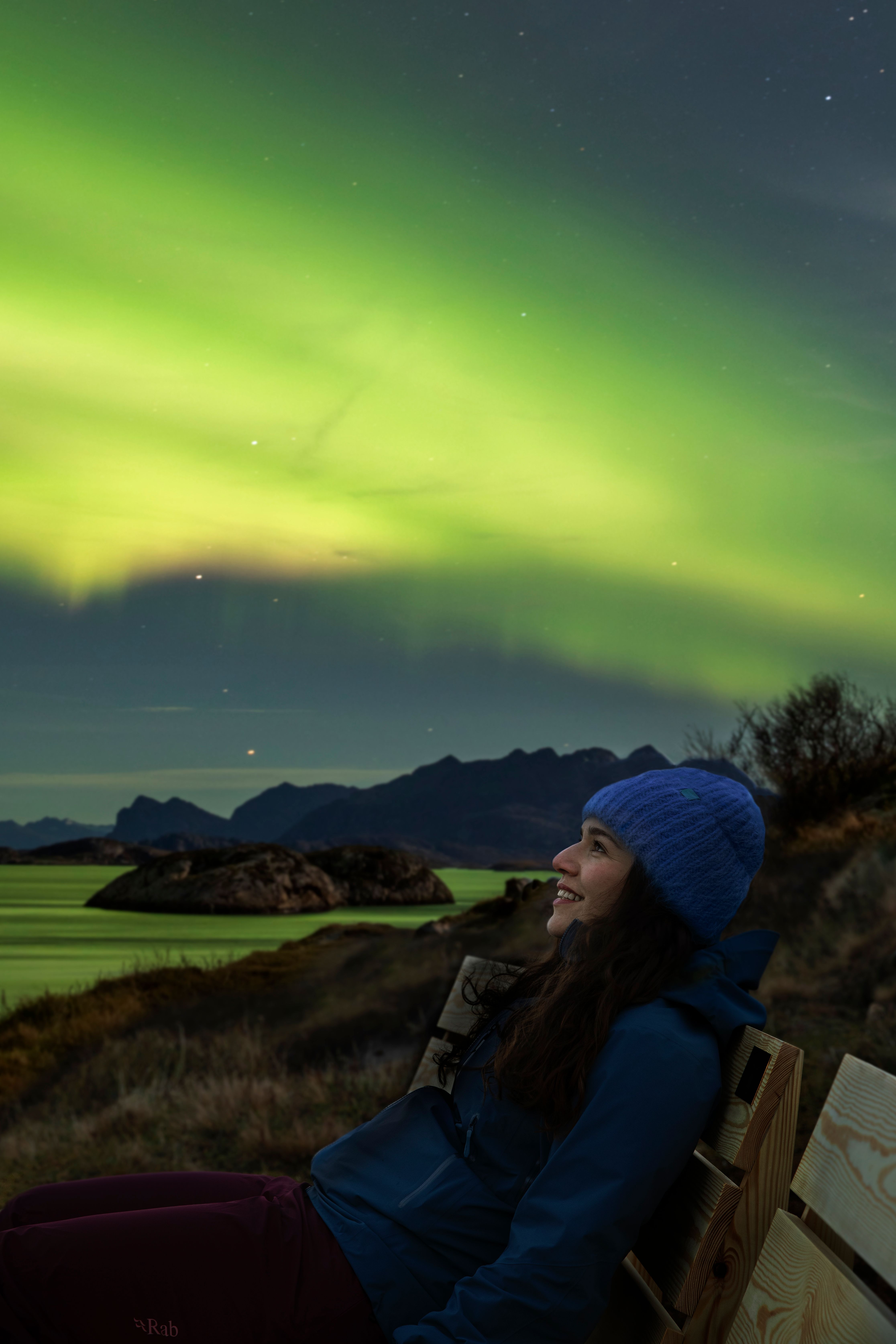 A woman looking at the Northern lights.