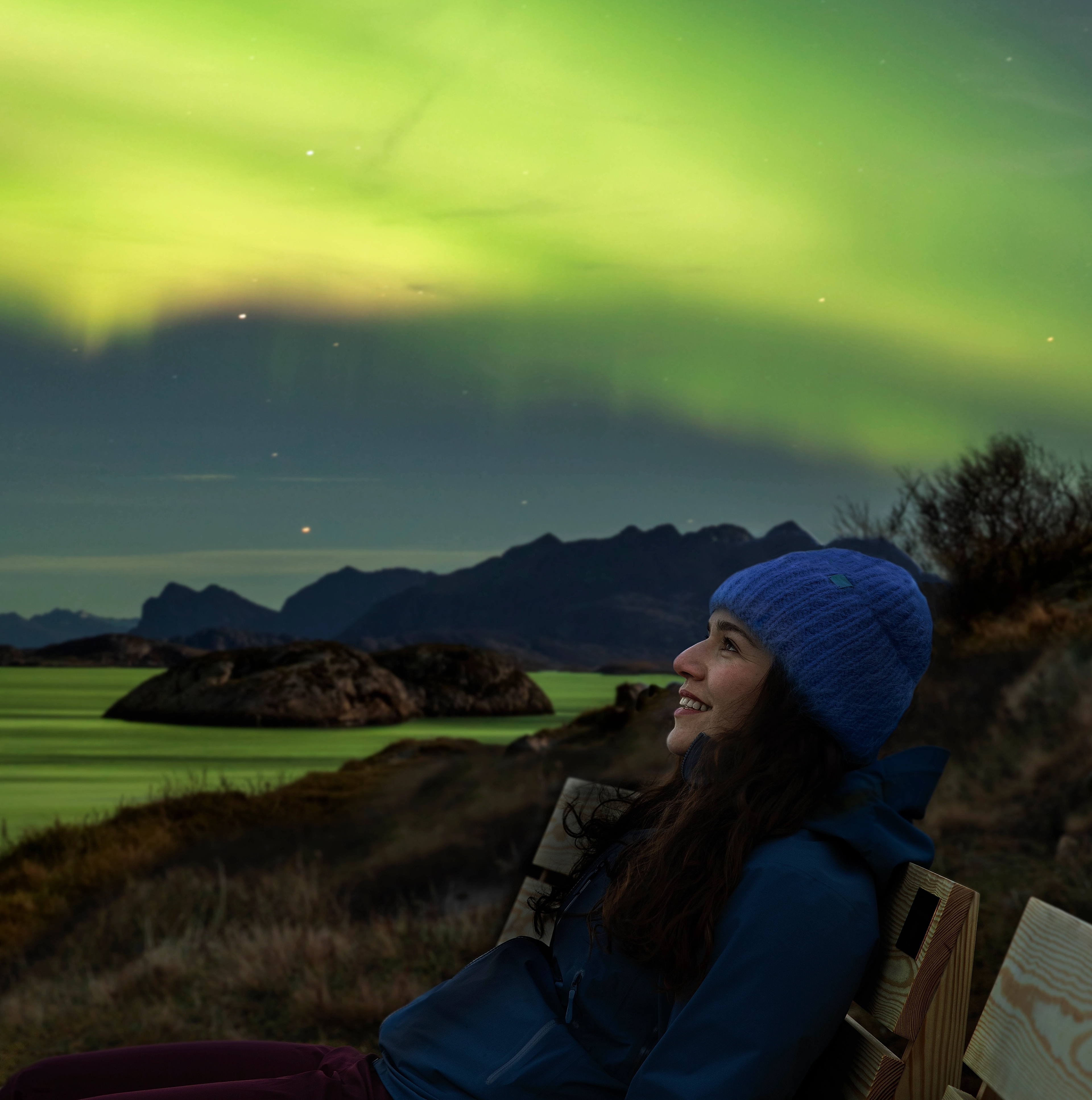 A woman looking at the Northern lights.