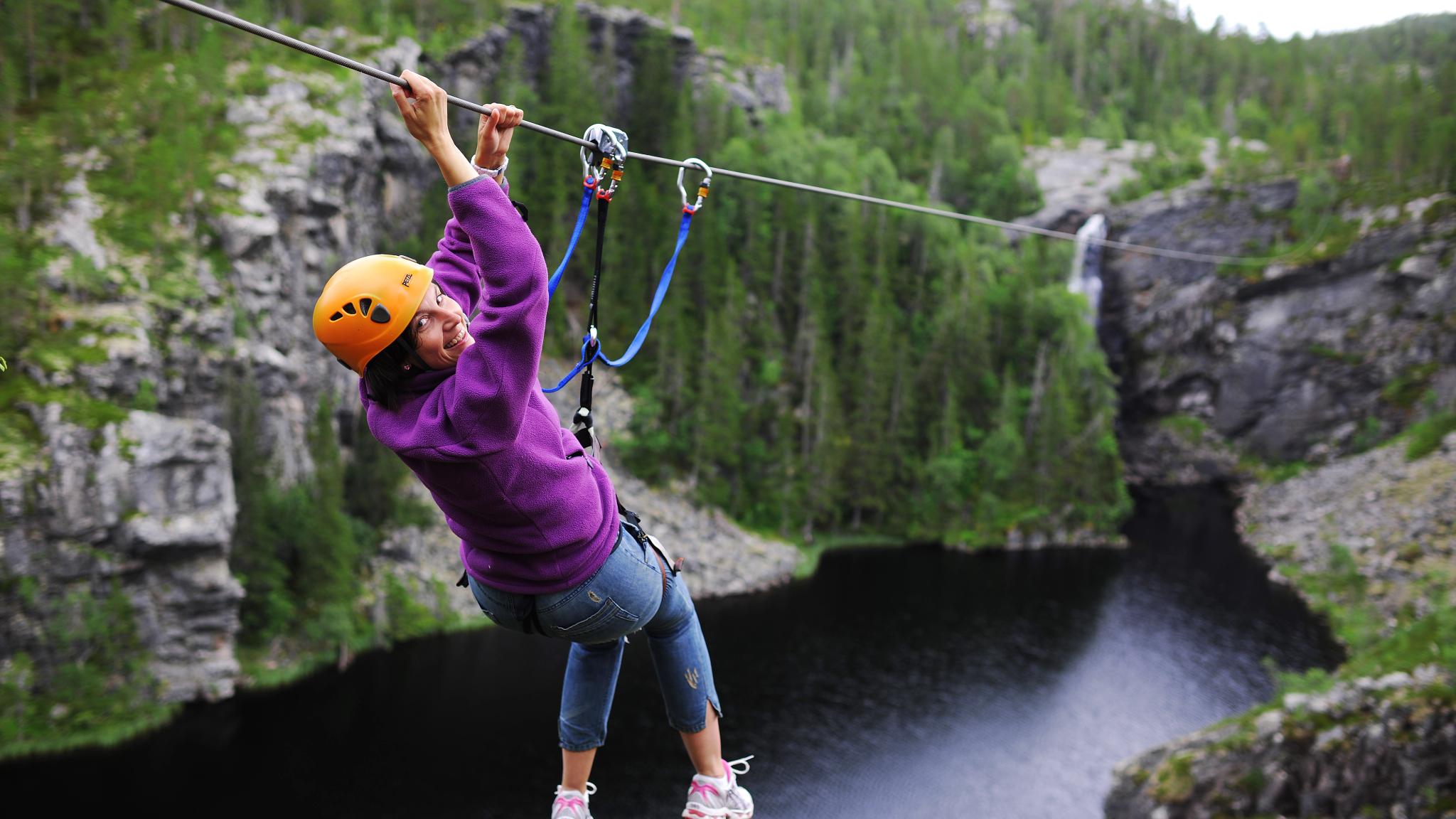 Woman ziplining in Rypetoppen Adventurepark