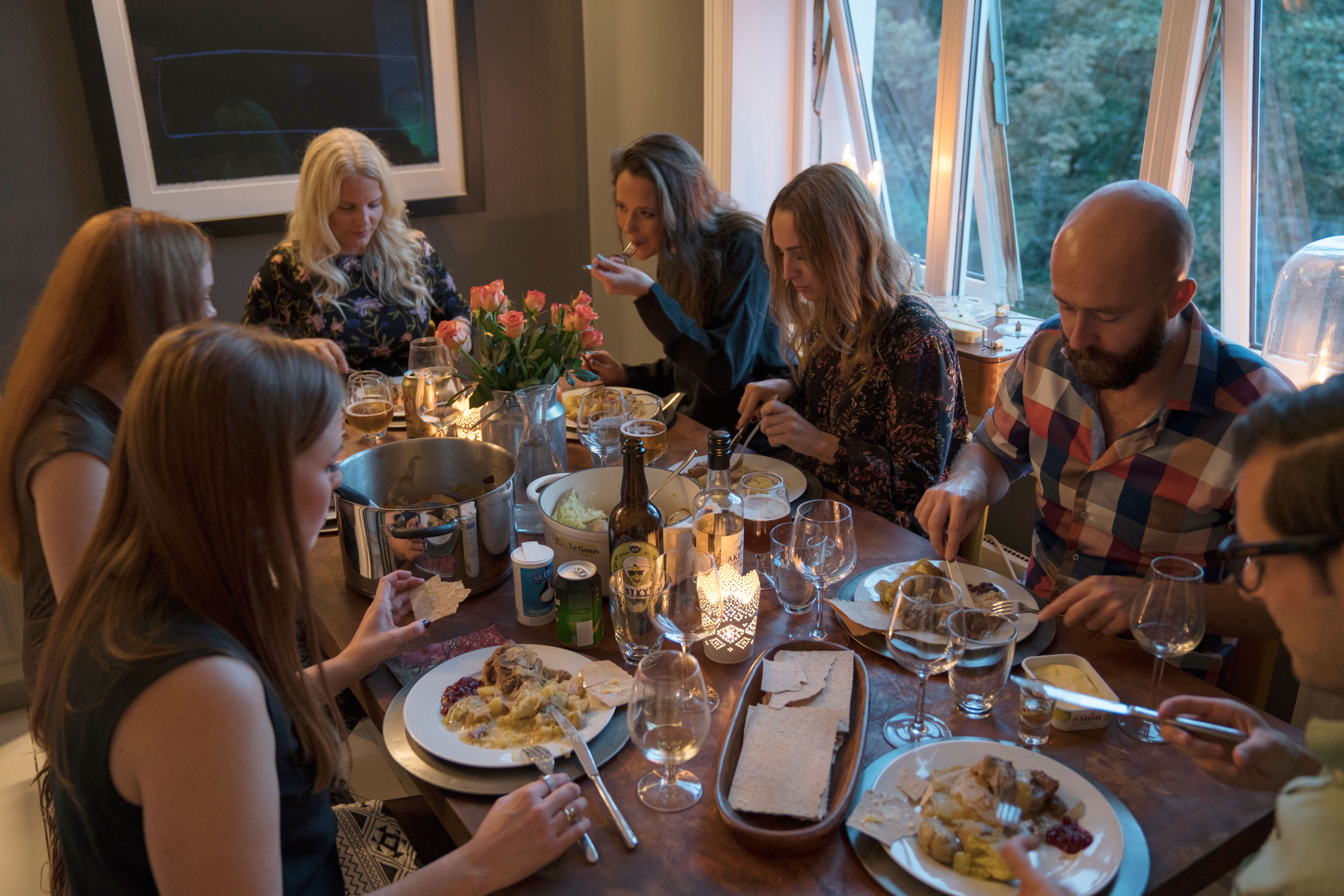 People around a dinner table eating fårikål lamb stew in Oslo, Eastern Norway